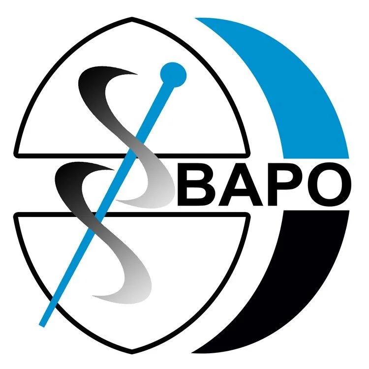 Logo for the American Association of Physicists in Medicine, featuring a shield, a caduceus with a blue rod, and the acronym 'BAPO'.