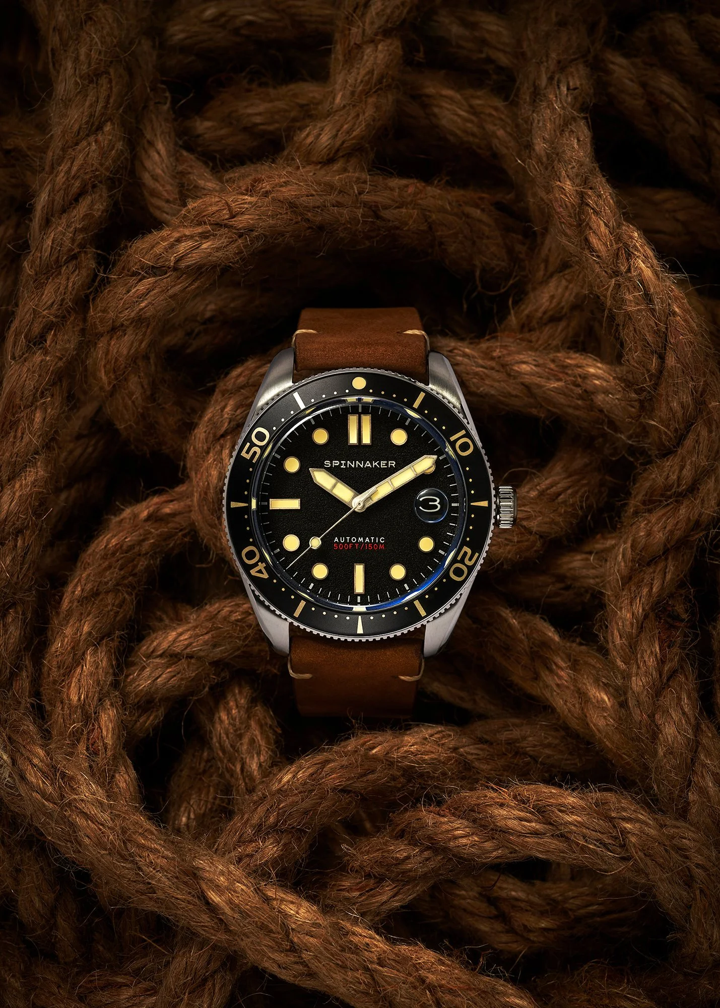 Spinniker Croft Mid-Size automatic divers watch lying on a pile of old roap
