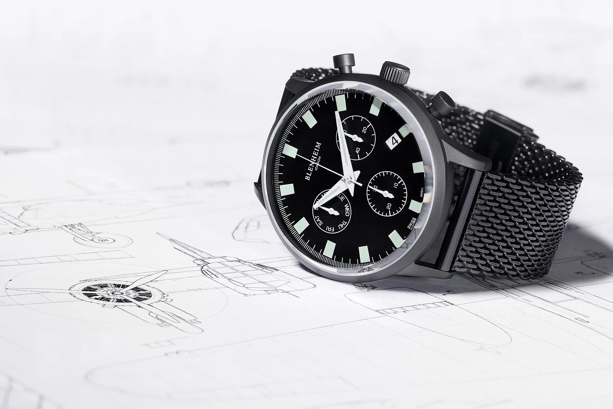 Black Chronomaster Pilot Watch lying on plans for the bristol blenheim plane