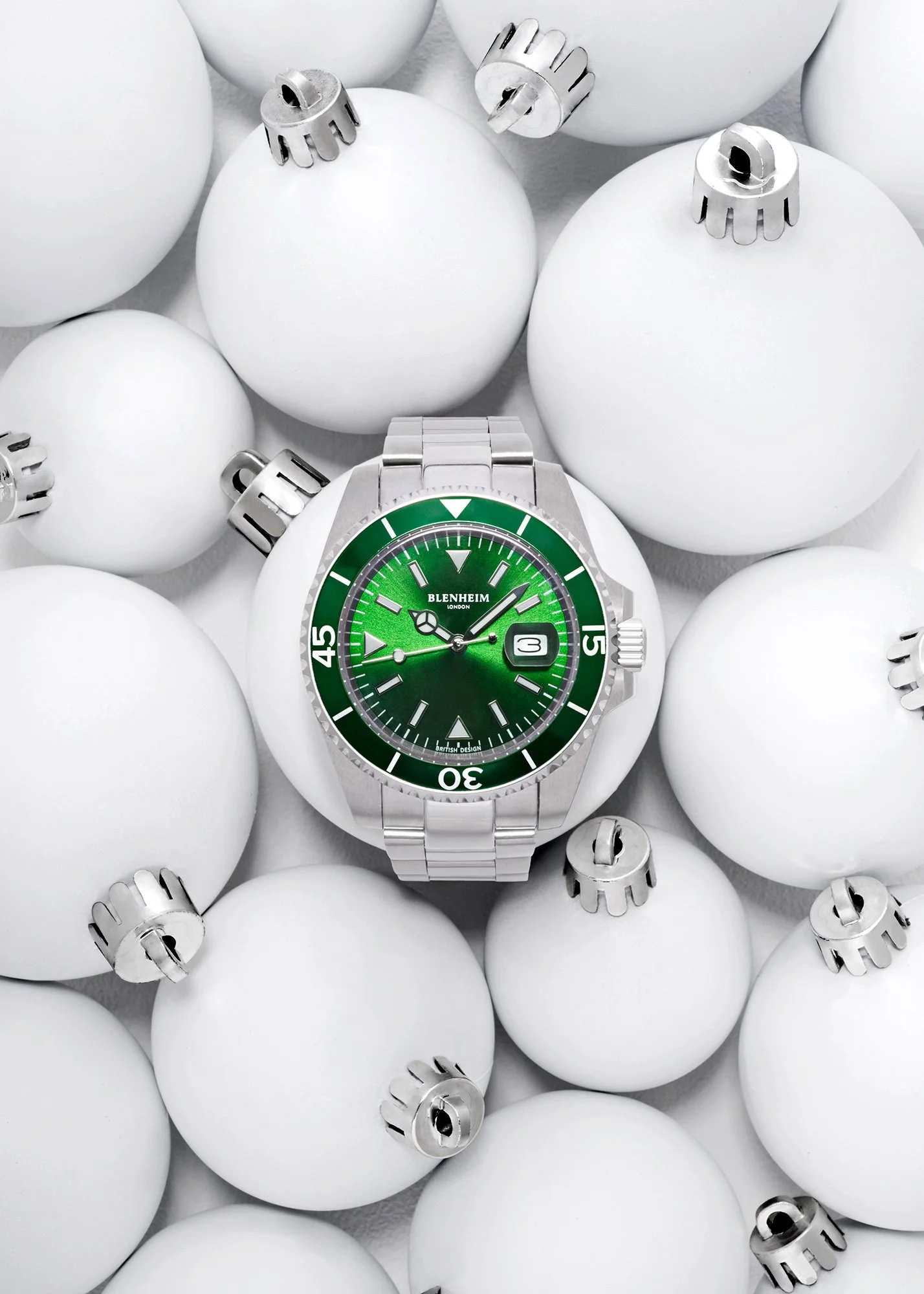 Christmas image of Green face Blenhiem Navigator watch rapped around a white christmas baubles