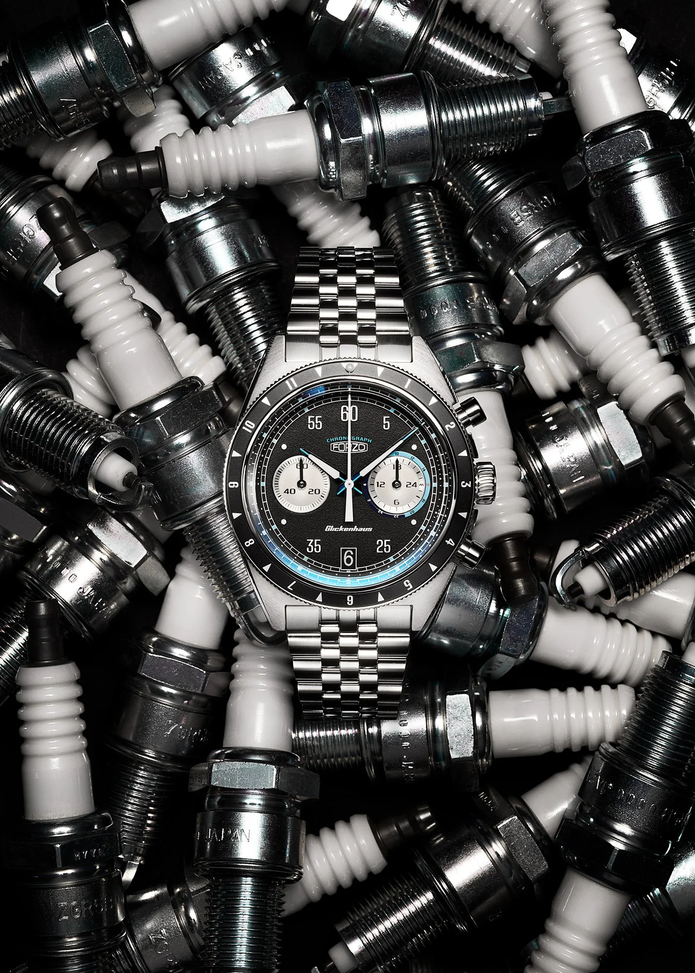 Forzo Drive King Glickenhaus Road to Race chronograph racing watch lying on a pile of spark plugs