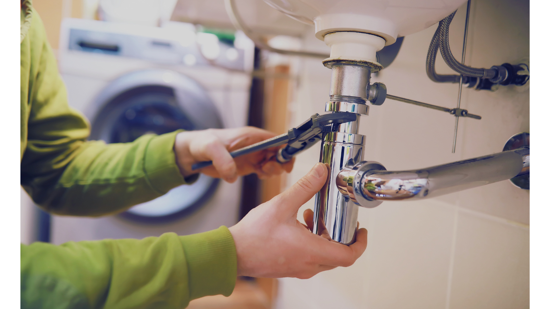 Person fixing a plumbing pipe under a sink with a wrench.