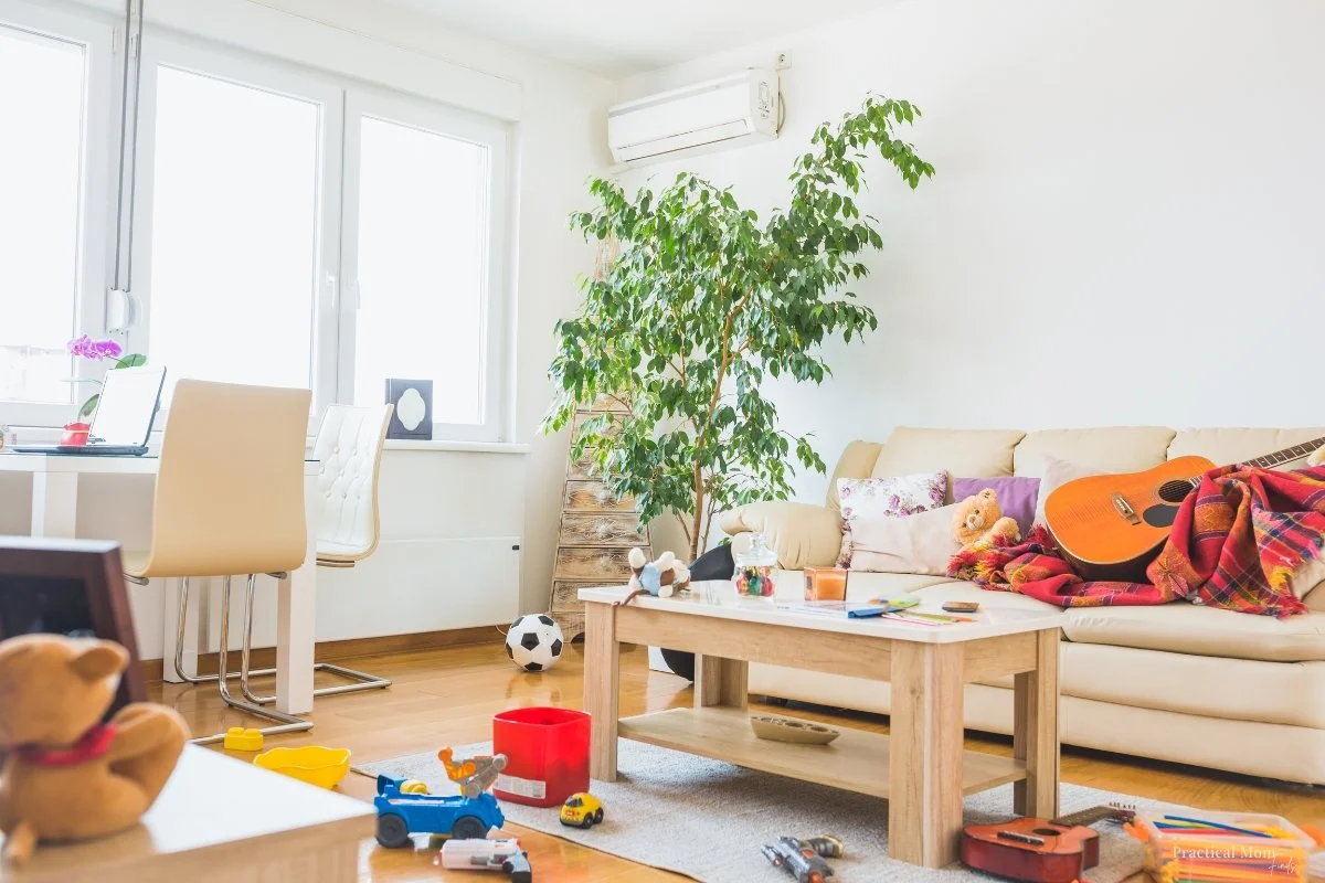 Family living room with kids' toys throughout the space, illustrating practical home organization for everyday family life.