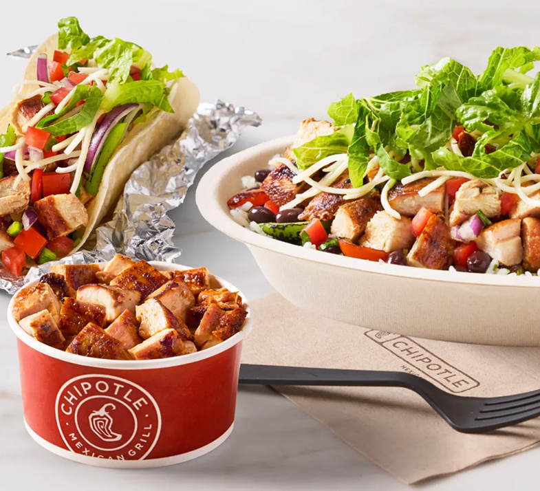 Salad, taco, and bowl of chopped grilled chicken from Chipotle fast food restaurant