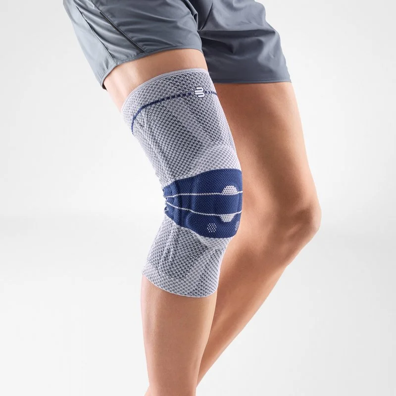 A person's leg wearing a gray knee brace with blue accents.