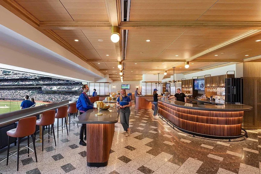 ospitality interior with a wood-paneled ceiling, bar seating, built-in counters, and patterned flooring.