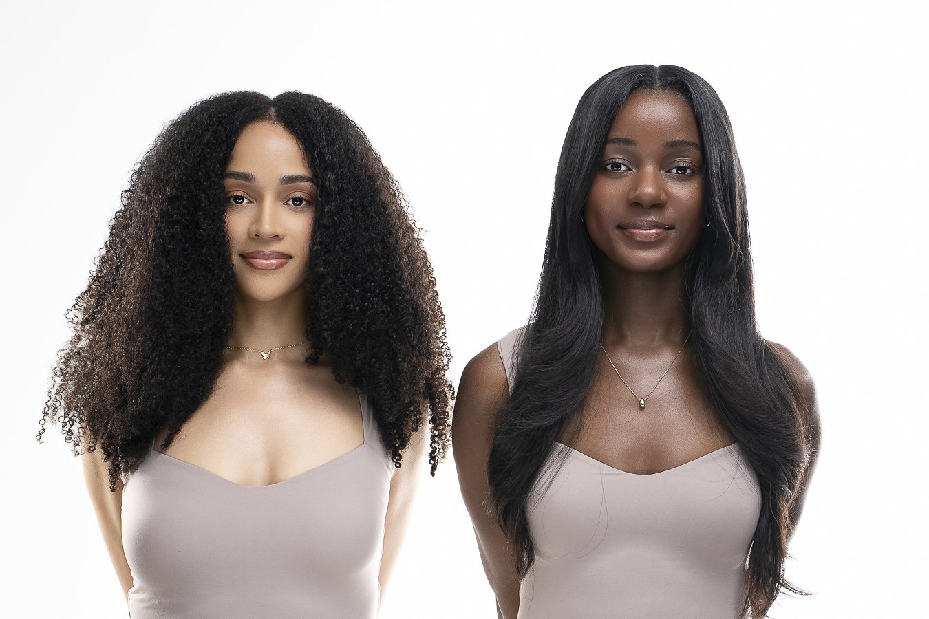 Two Black women, Love Luxury clients wearing raw Vietnamese straight bundles and afro curly hair bundles in a Kansas City hair salon studio, natural hair  and sew in services by stylist Imani Love.