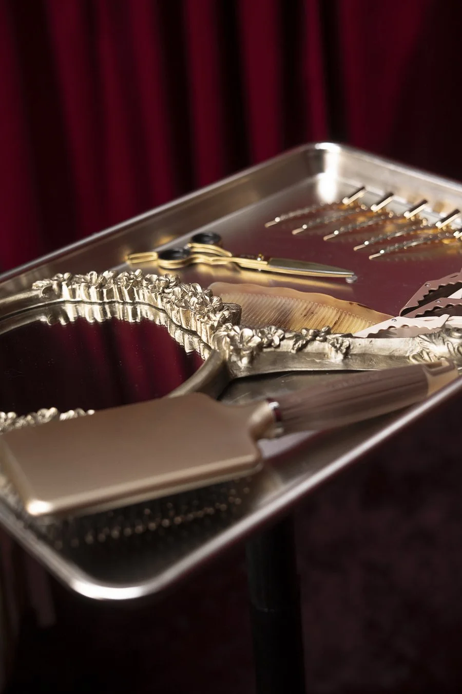 Luxury hair styling tools on a silver tray with fancy scissors and clips, Love Luxury salon Kansas City.