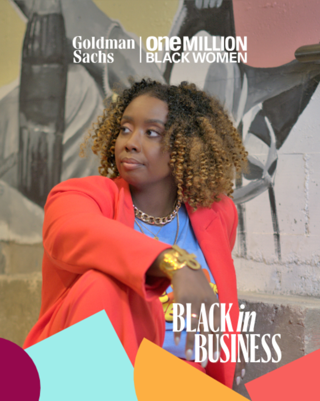 Tiffany Lindley with curly hair wearing a red blazer, gold jewelry, and a blue T-shirt, sitting in front of a black-and-white mural background, with text overlay promoting Goldman Sachs' One Million Black Women initiative.