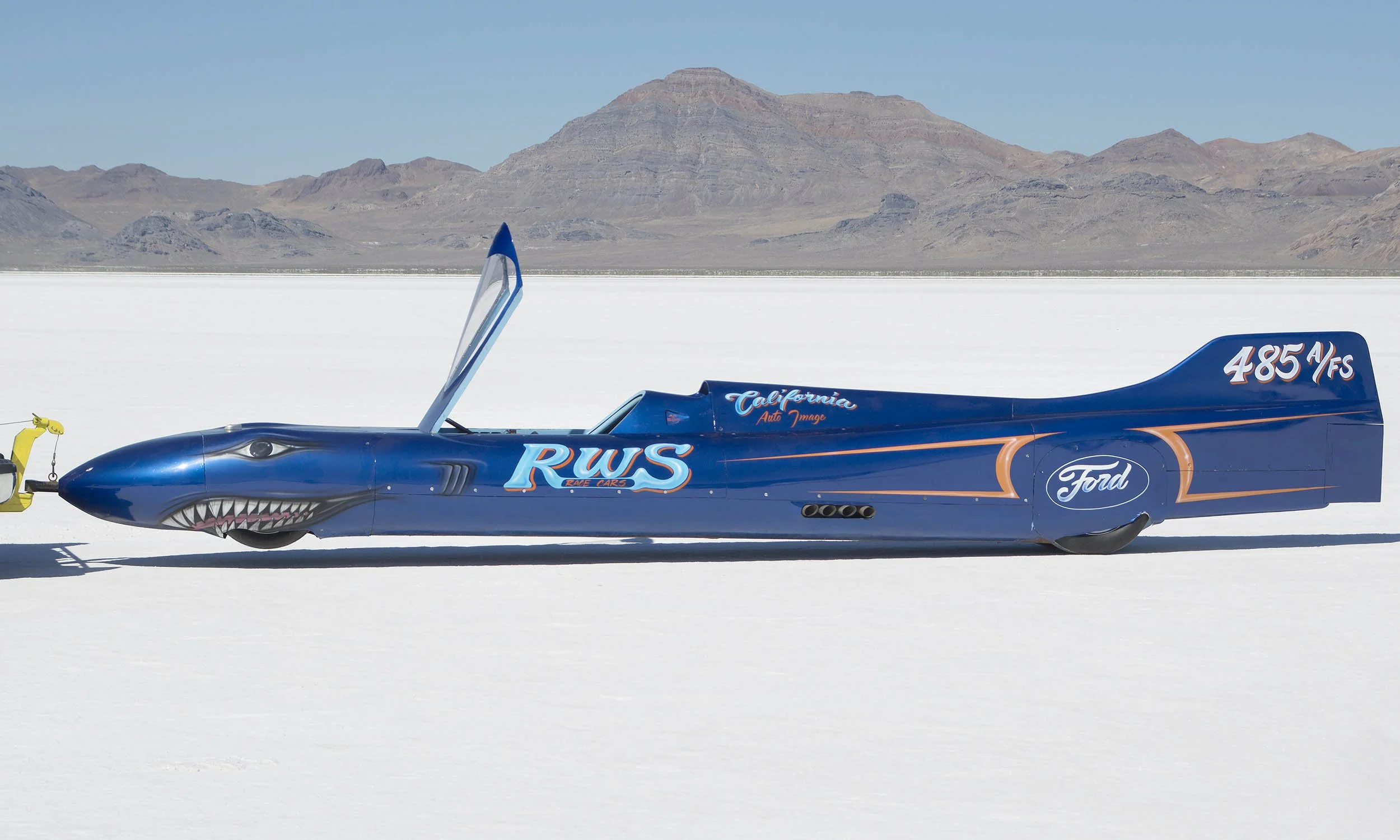 A blue streamliner w/Ford engine, and shark face artwork on the nose. 