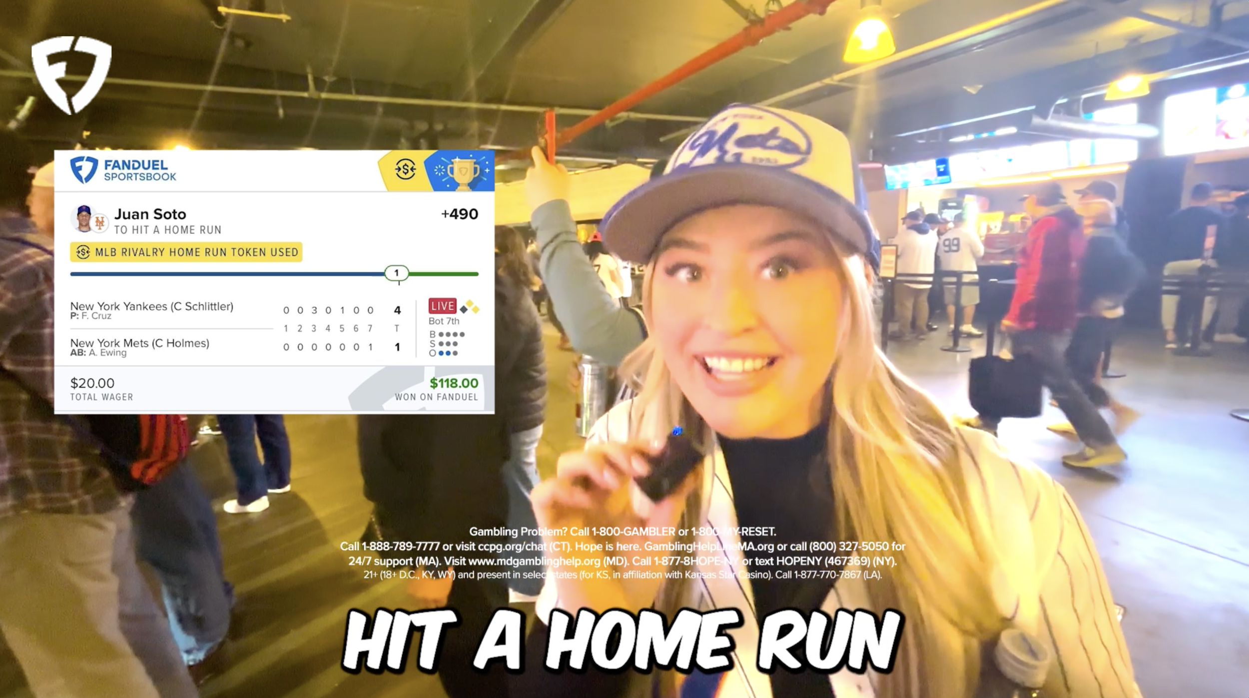 A woman in a baseball cap smiling and speaking into a microphone at an airport or station, with a digital betting slip overlay showing a winning sports wager on a New York Yankees game, celebrating a home run. People are in the background, some with luggage, in a lively setting.