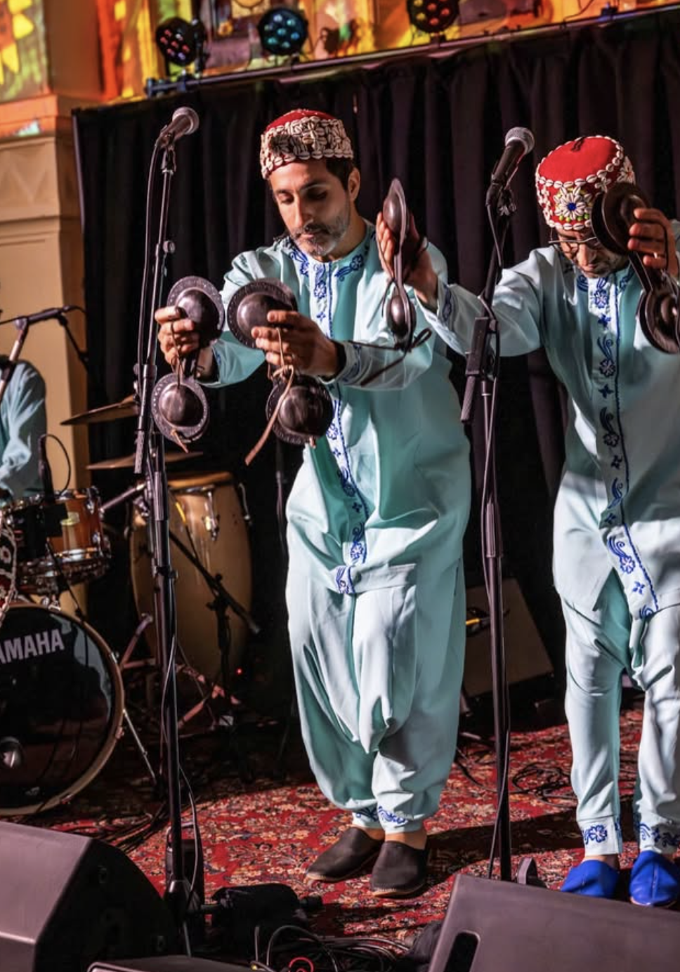 Members of  Saha Gnawa performing live with traditional qraqeb percussion.