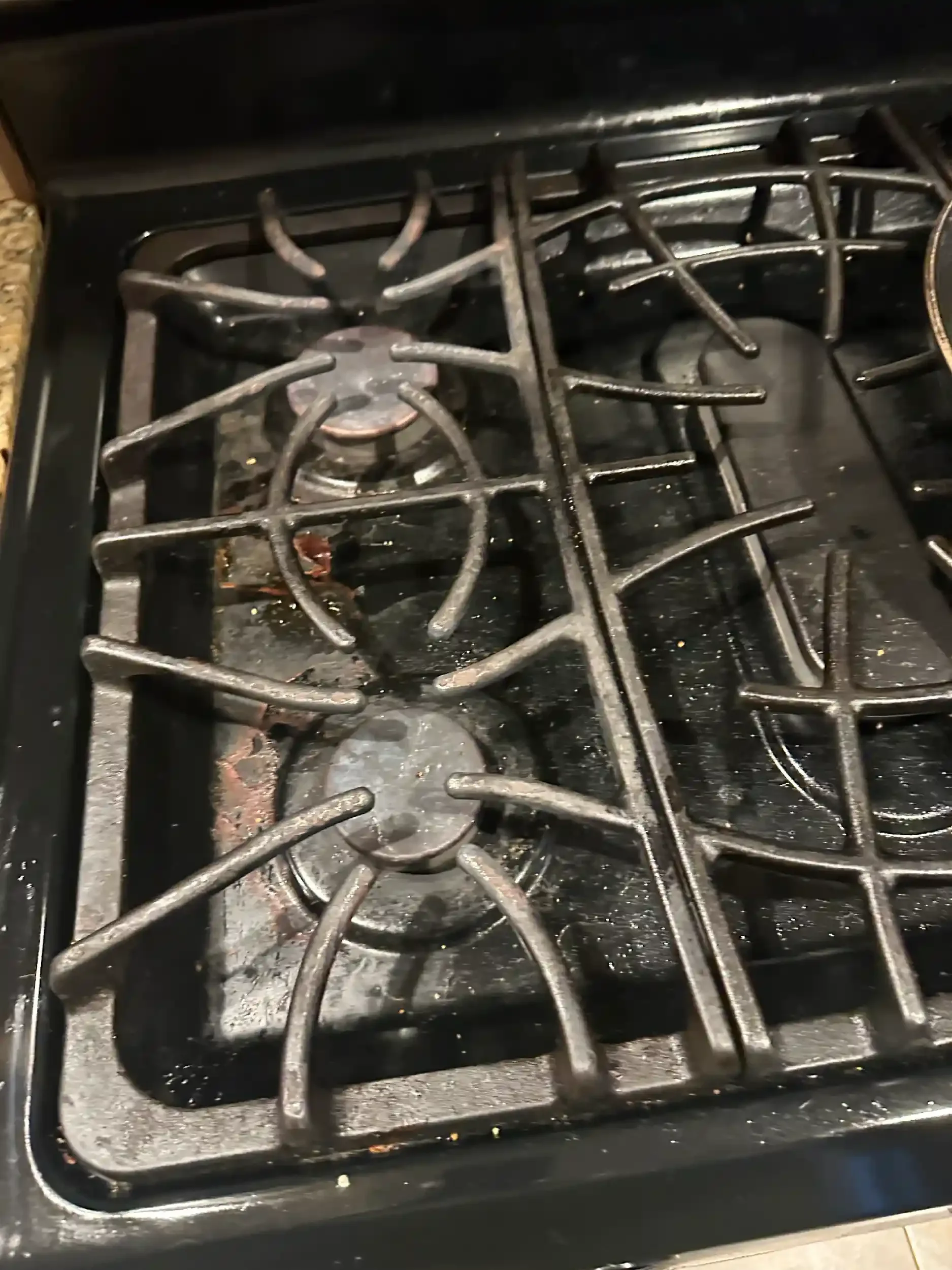 Burned and dirty stovetop burners with some residue and grime.