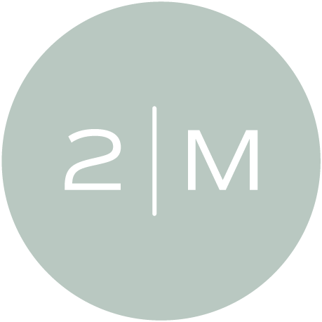 A circular logo with a light gray background and black text displaying '2 | M' in the center.