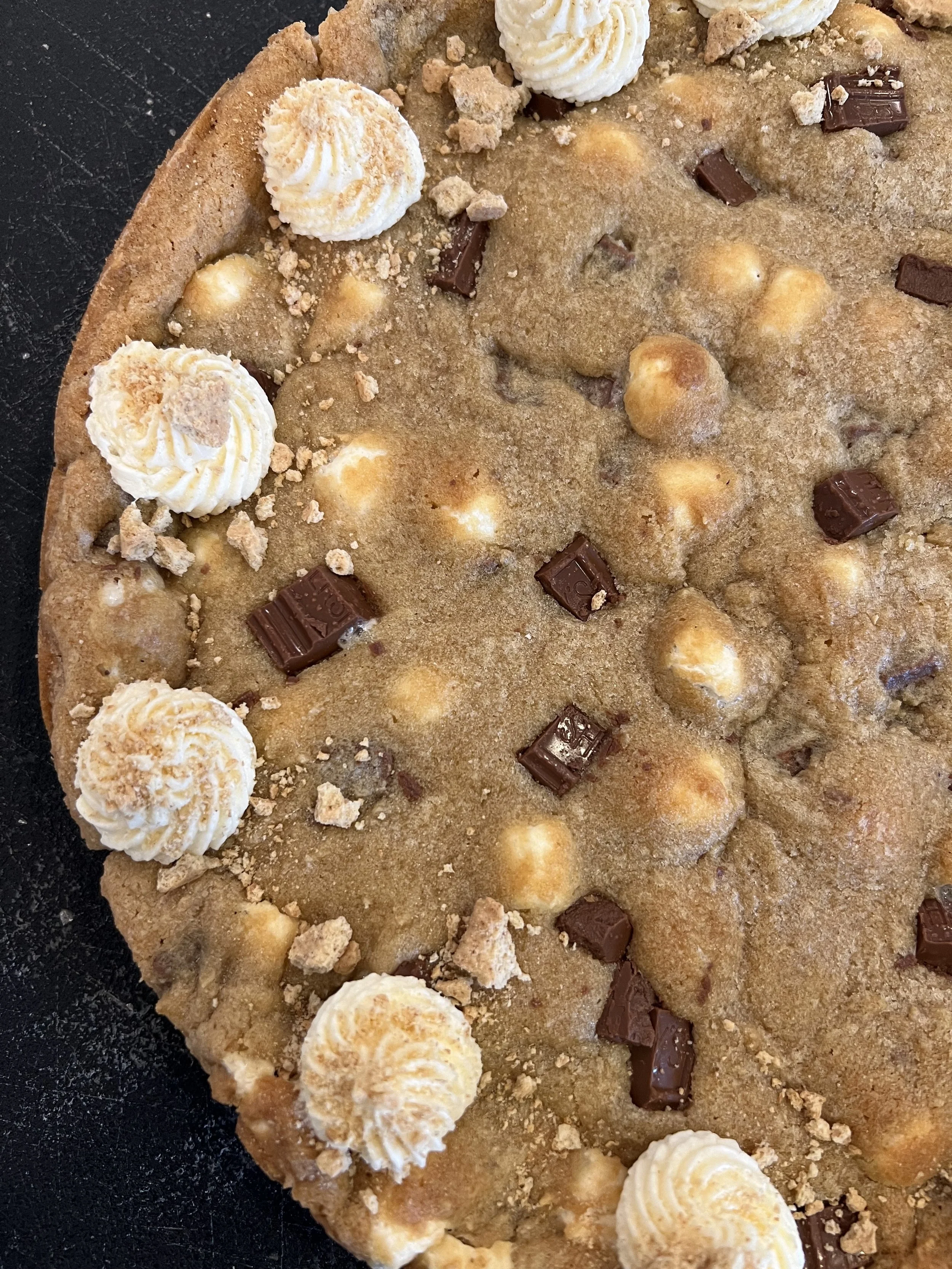 S'mores cookie cake with milk chocolate chunks, melty marshmallows and graham cracker crust