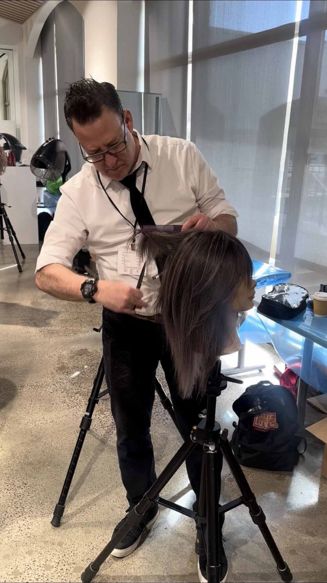 Dan Good Hair hairstylist demonstrating precision haircut technique on lavender hair hair