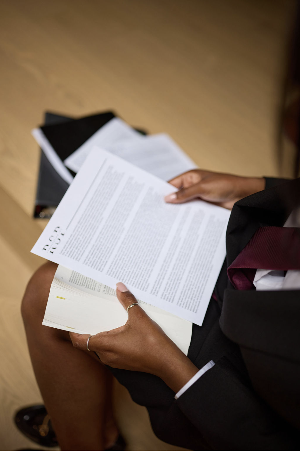 Lawyer holding legal paperwork on her lap.