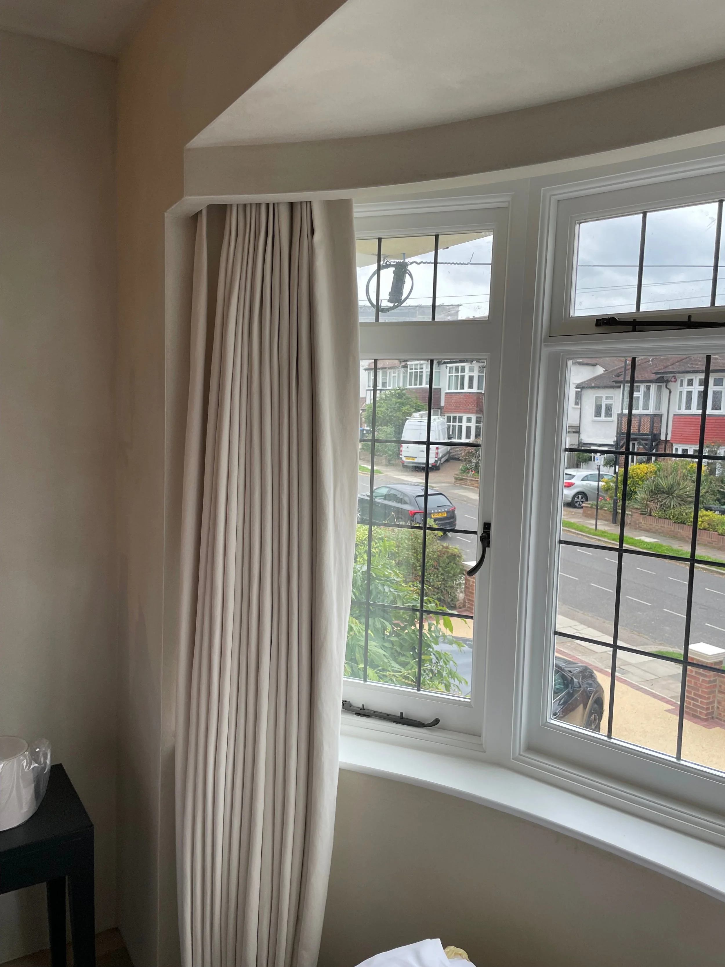 bay window with curtain behind built in pelmet