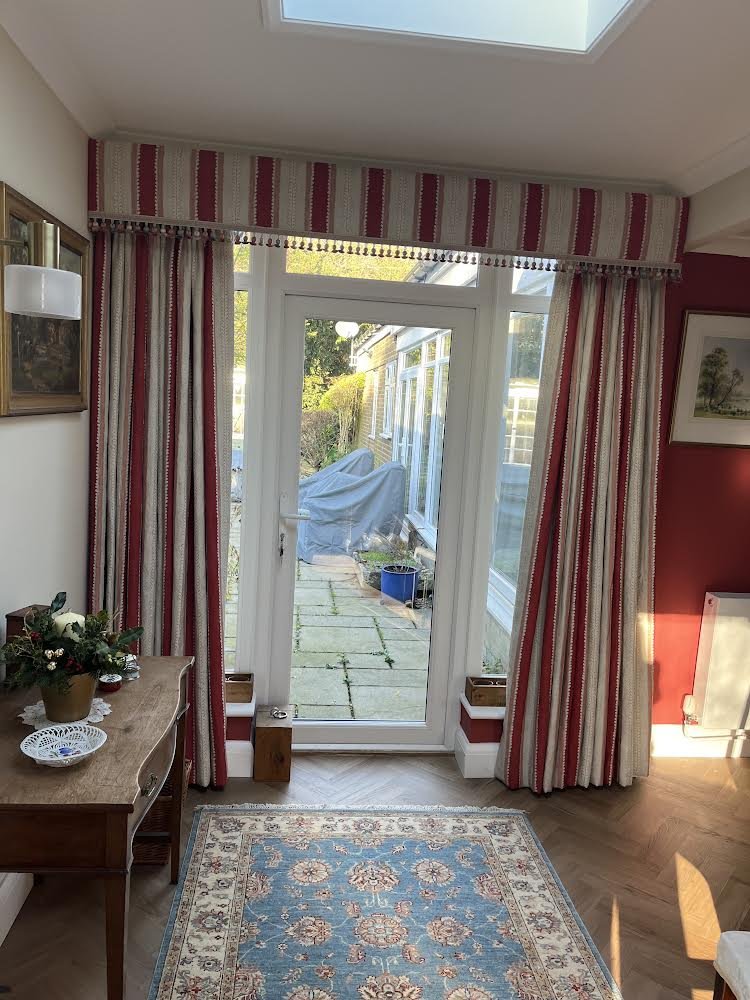upholstered pelmet and trim and interlined red striped curtains