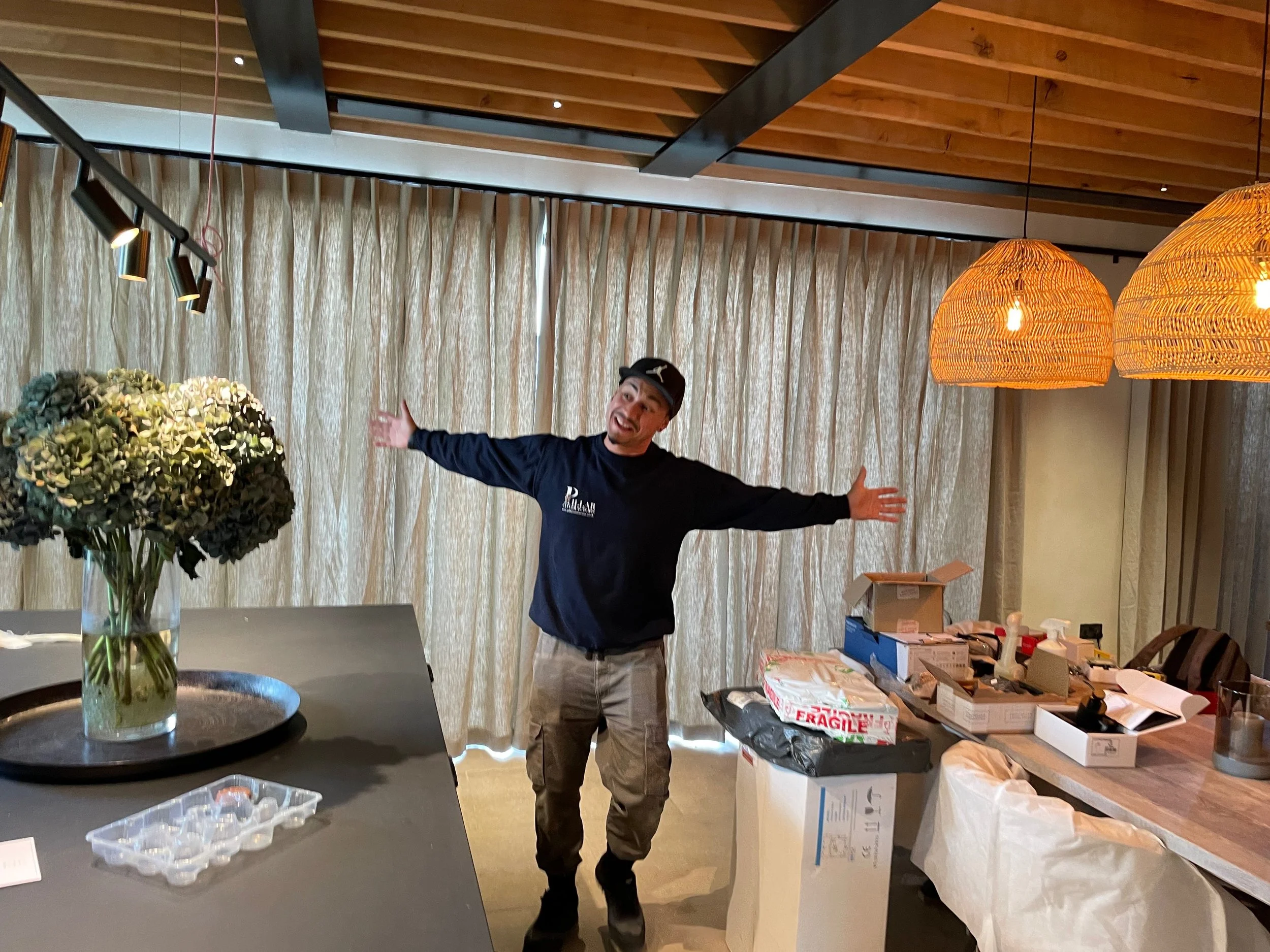 helpful builder with linen curtains in kitchen diner