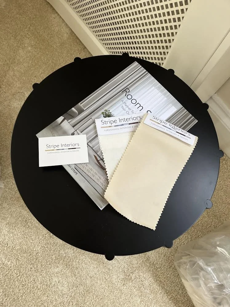 side table with room story planner and fabric swatches