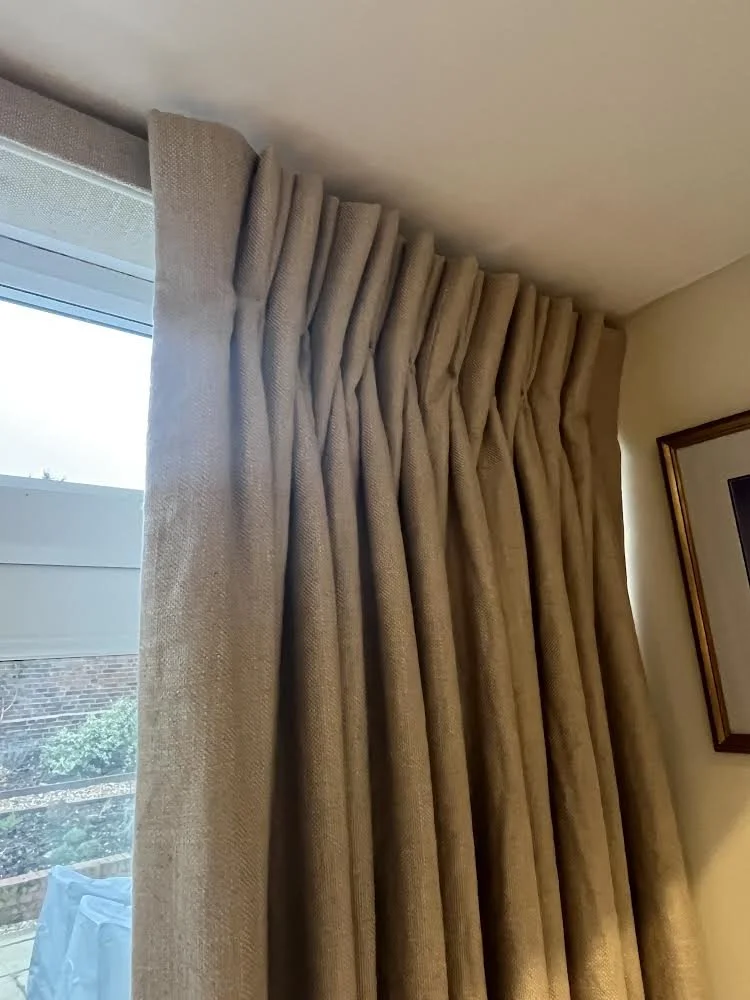 close up of double pleat gold curtains on lathe and fascia track
