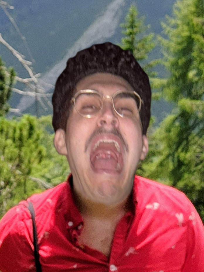 A person with glasses and dark hair wearing a red shirt, making an exaggerated facial expression with mouth open, in a forest background.