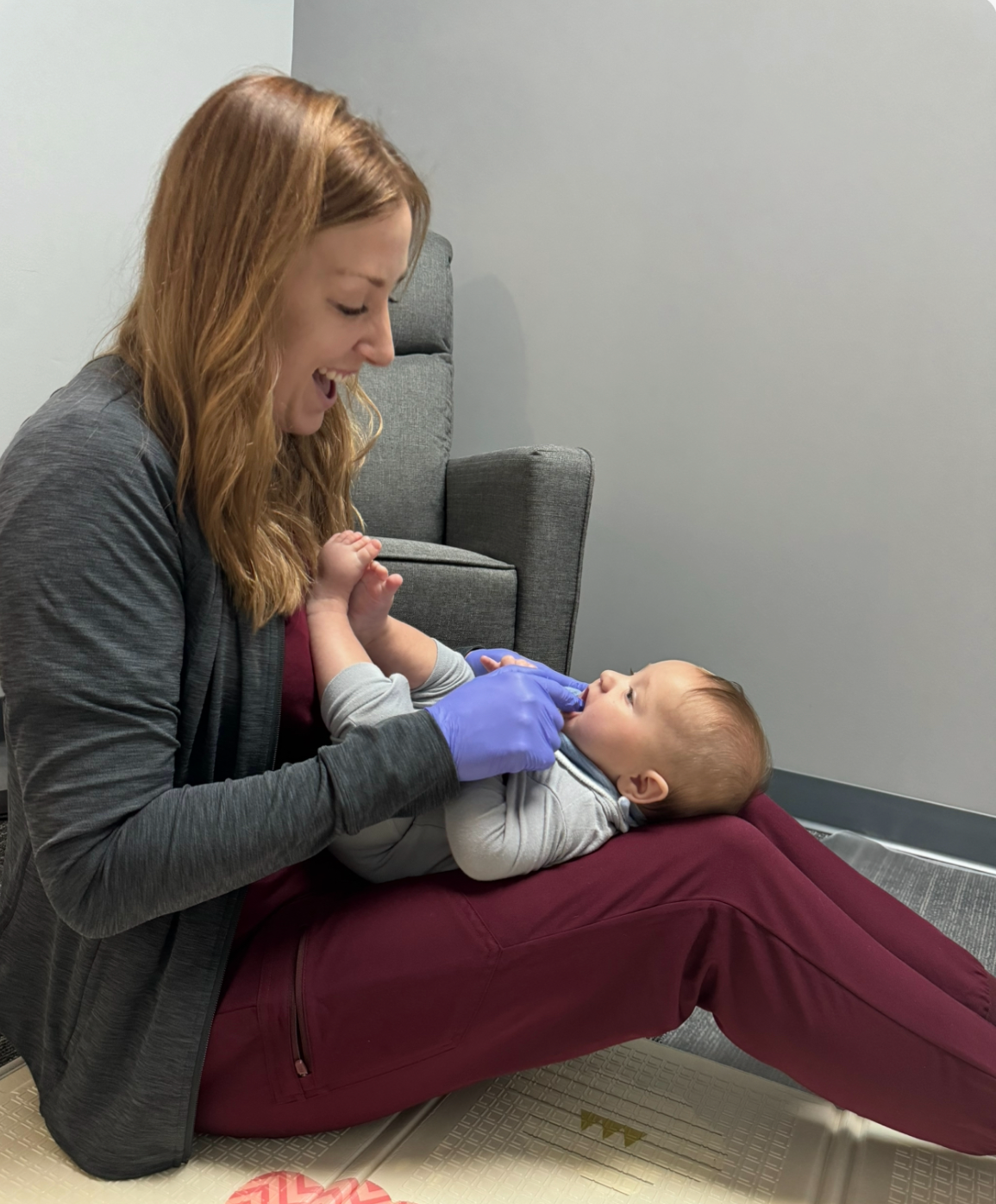 Dr. Jenn Moore performing a comprehensive infant feeding evaluation to assess oral motor function and feeding skills.