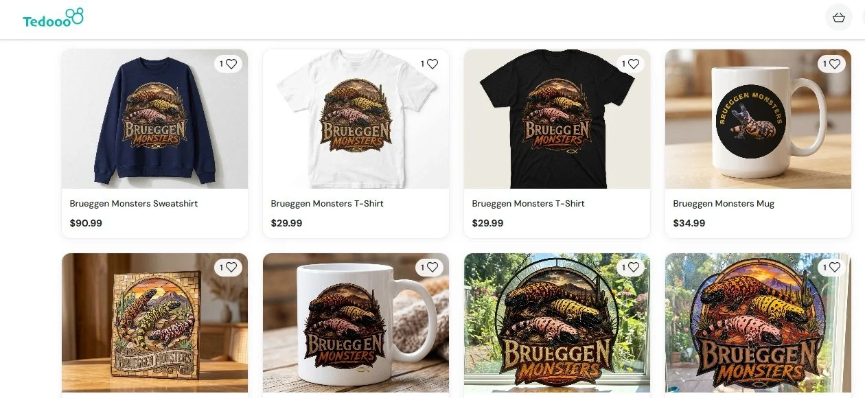 Various merchandise including sweatshirts, T-shirts, mugs, and artwork features a colorful Gila Monster designs with the text "Brueggen Monsters."