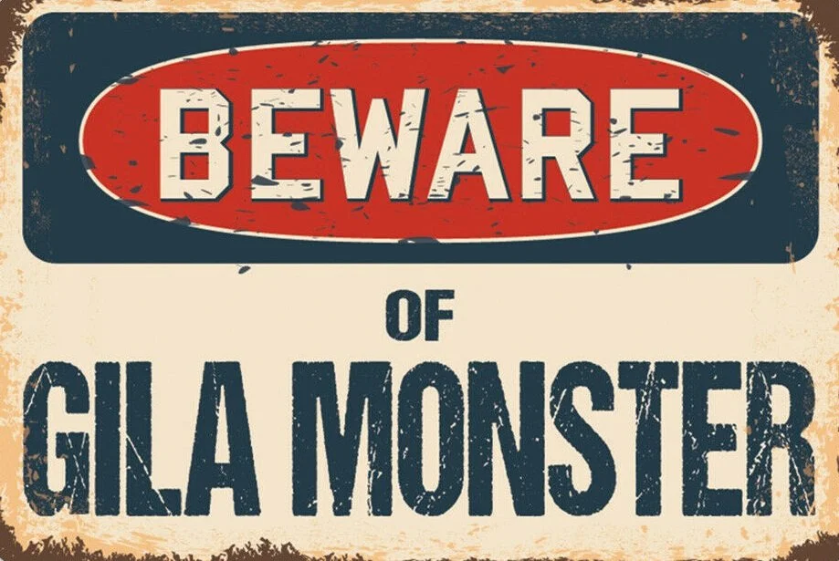 Vintage-style sign reading 'Beware of Gila Monster' with worn textures and a distressed look.