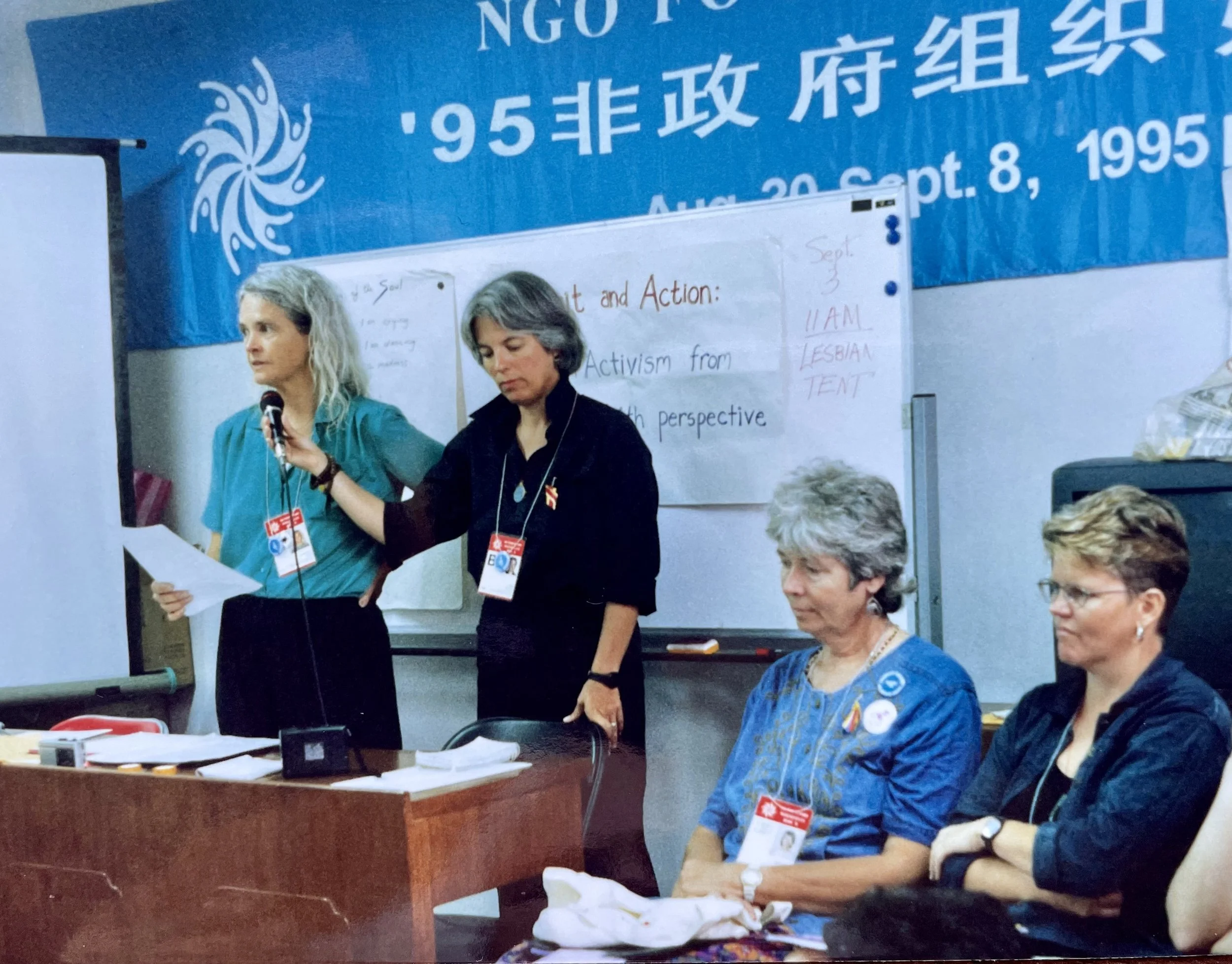 Judith, Victoria Rue (playwright and activist), Sandy Boucher (writer, feminist, Buddhist leader), and Selisse Berry (founder of Out & Equal Workplace Advocates) at the 1995 Fourth World Conference on Women, in Beijing, China.  Judith is standing up