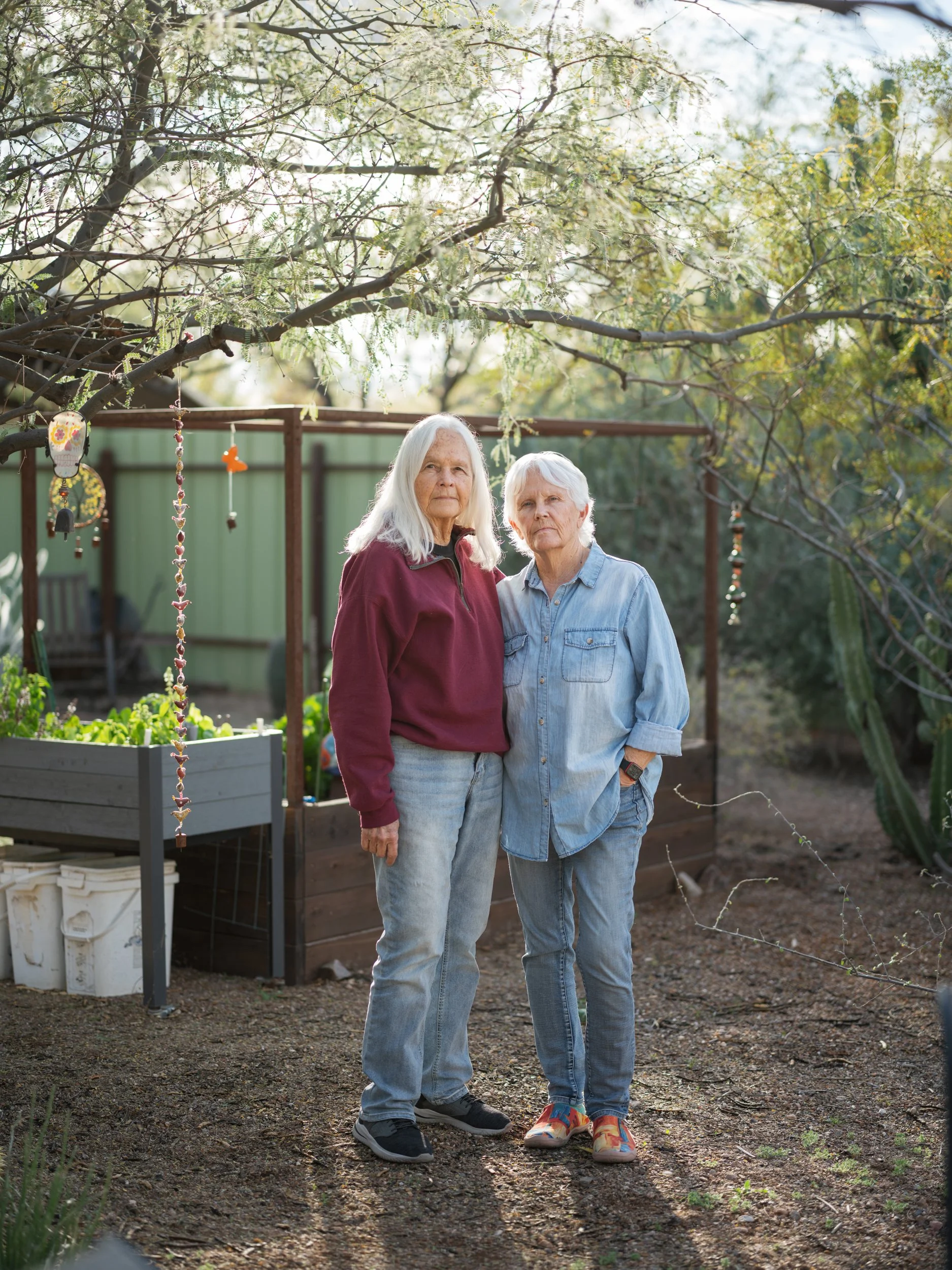 judith mcdaniel and partner jan schwartz standing side by side in garden