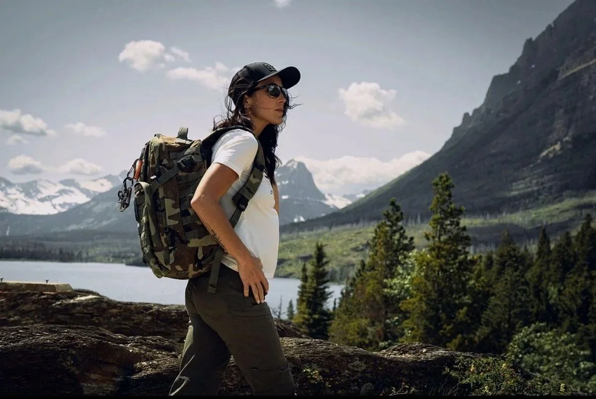 Lauren Hamm, Whitefish Montana REALTOR®, hiking above a mountain lake in the Flathead Valley
