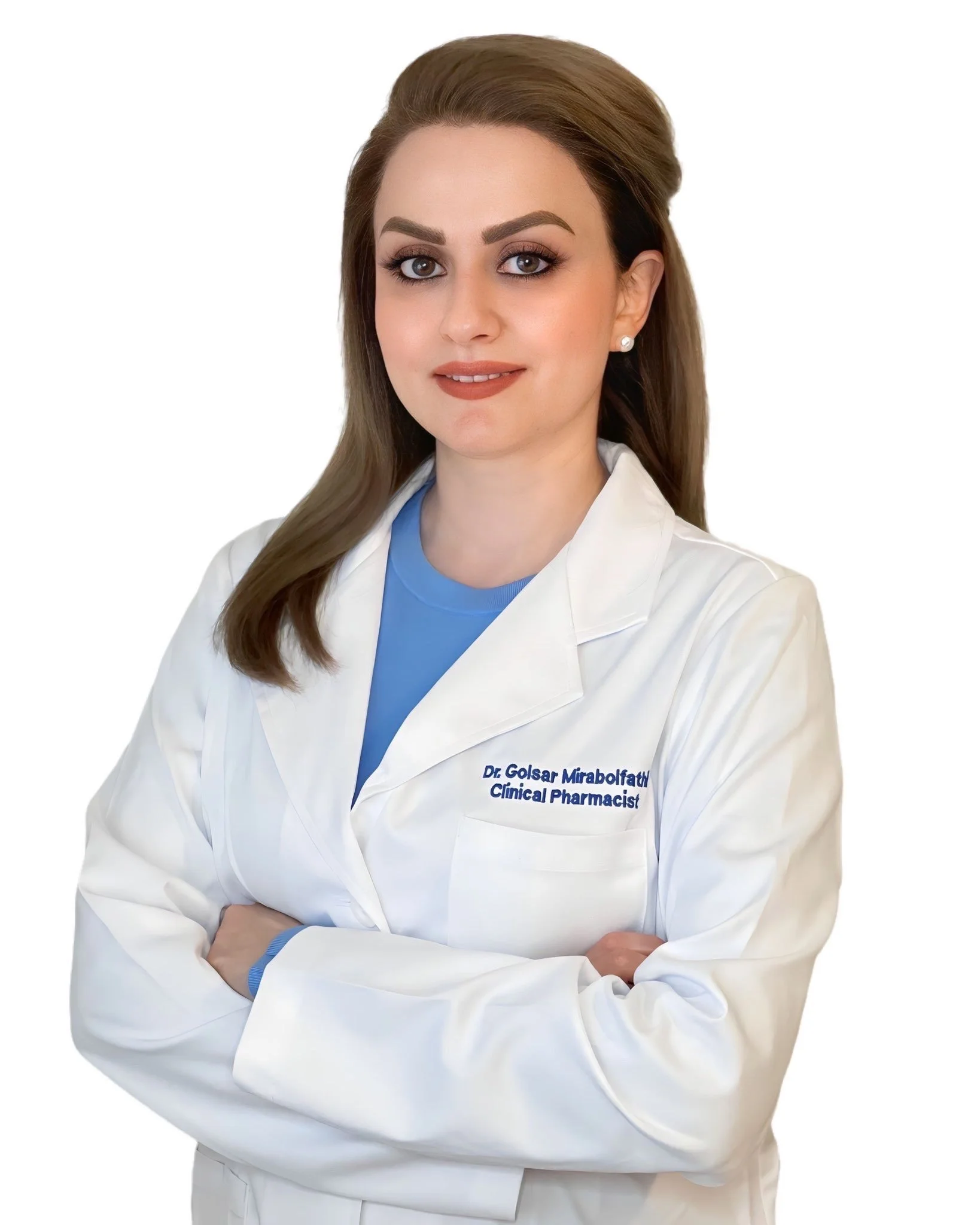 Portrait of a female healthcare professional wearing a white coat with her arms crossed, standing against a plain white background. She has long, brown hair styled in loose waves, blue eyes, and is wearing pearl earrings. The coat has her name and title embroidered on it, reading 'Dr. Golsar Mirabolfa, Clinical Pharmacist'.