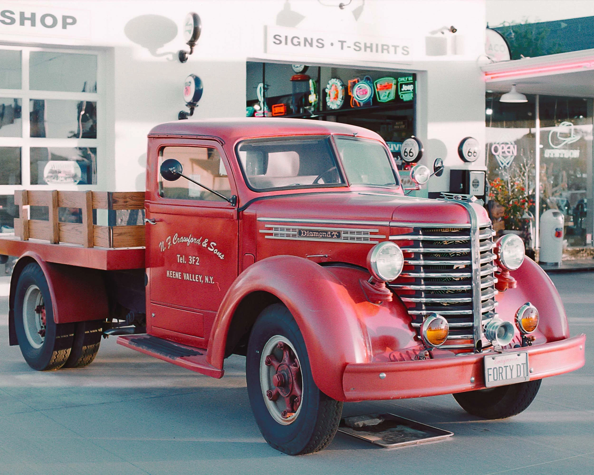 Red vintage truck with a wooden flatbed.