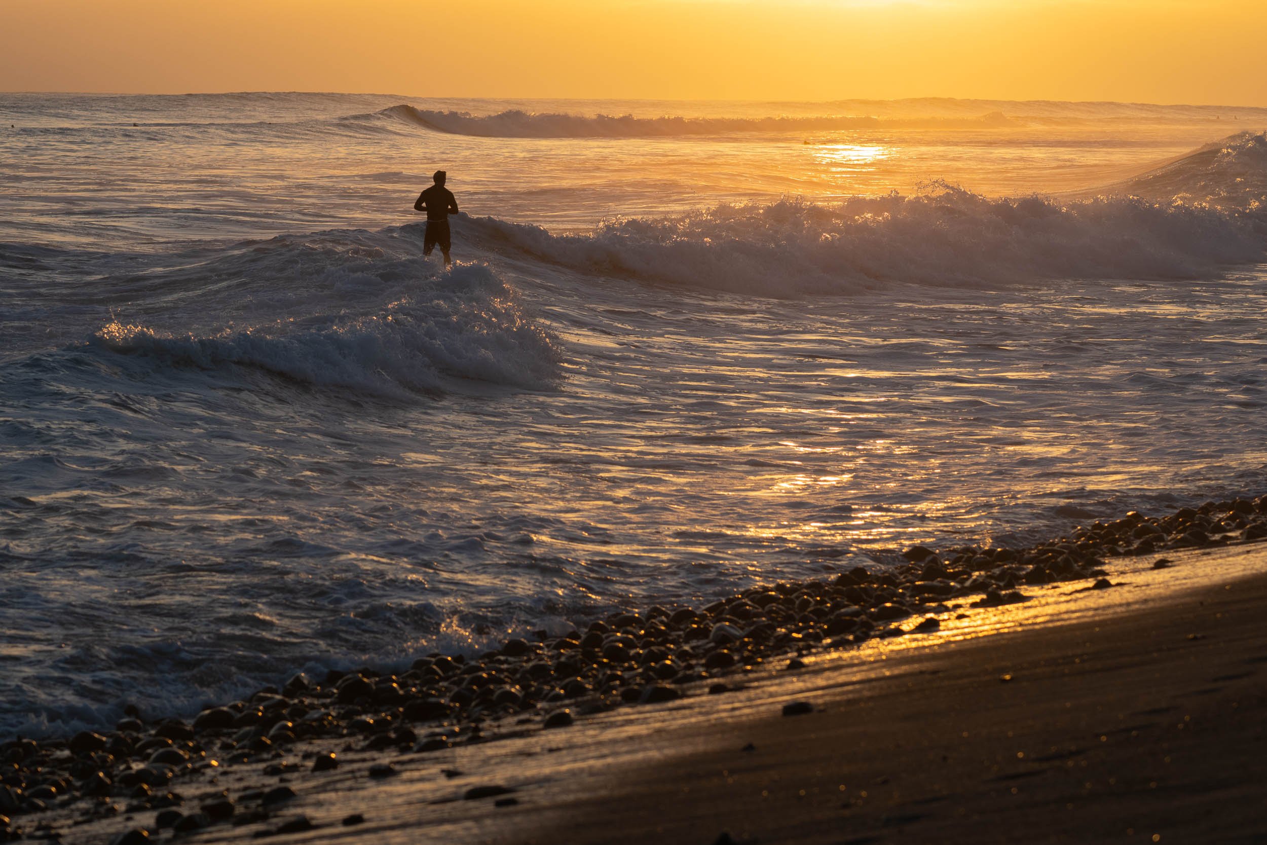 Surfer at sunset lower trestles
