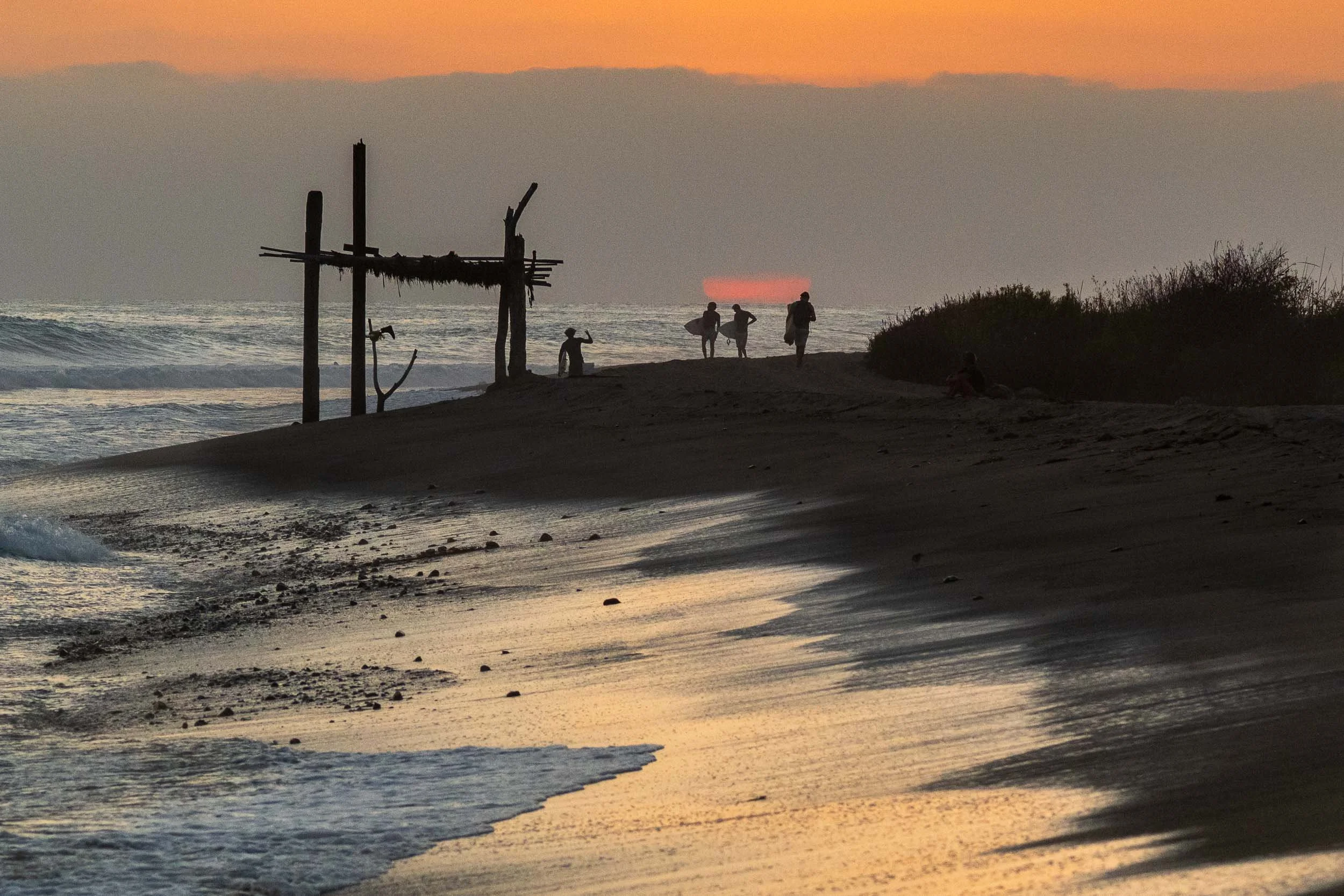Surfer silhouette at sunset lower trestles