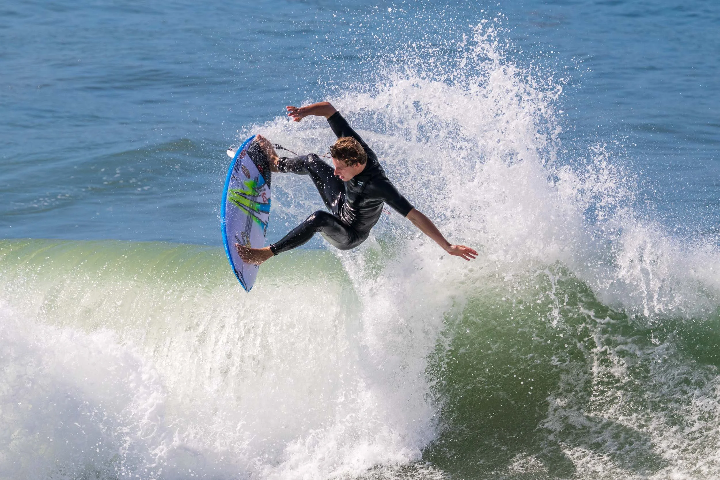 Airborne surfer at Huntington Beach