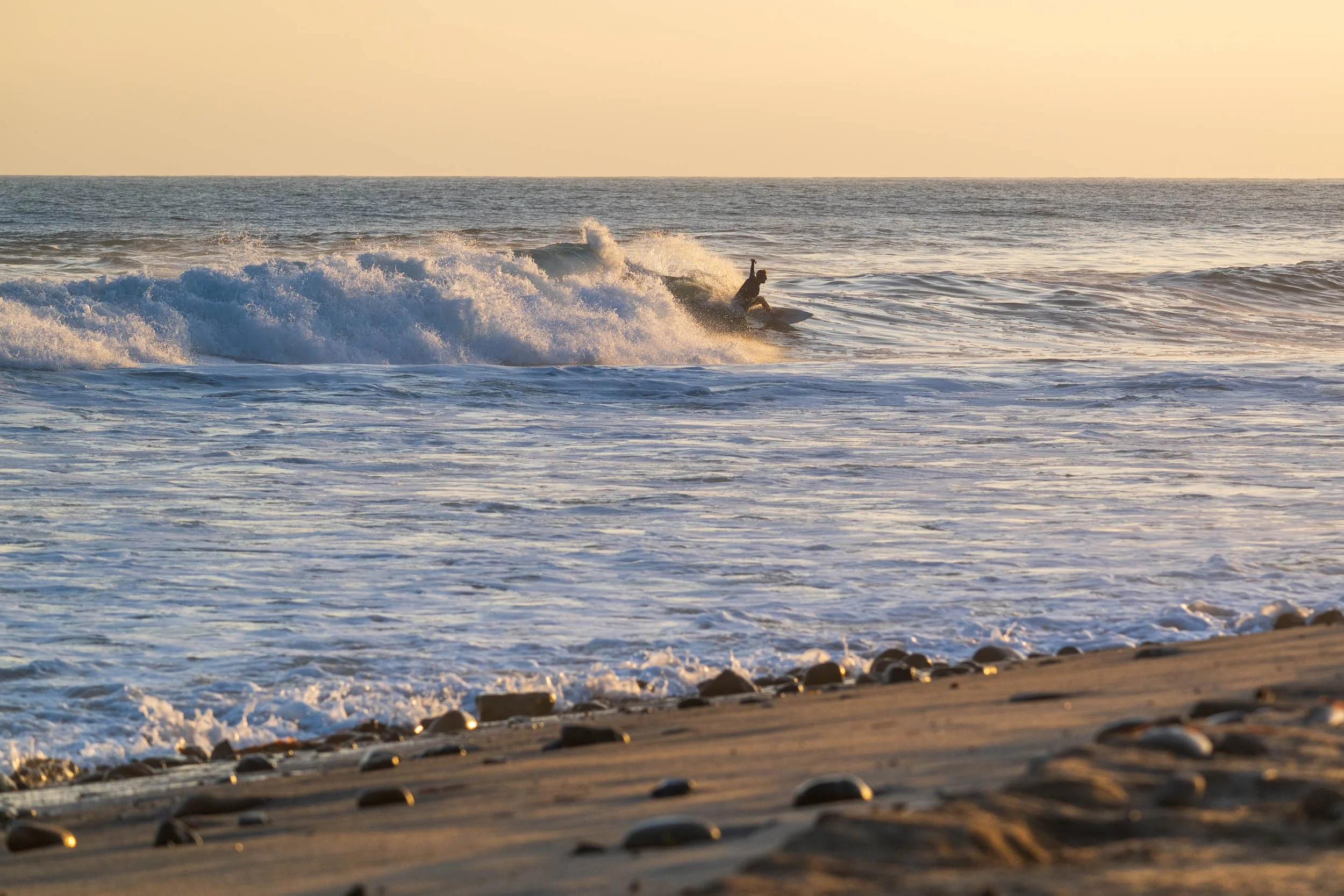 Surfer silhouette at sunset lower trestles