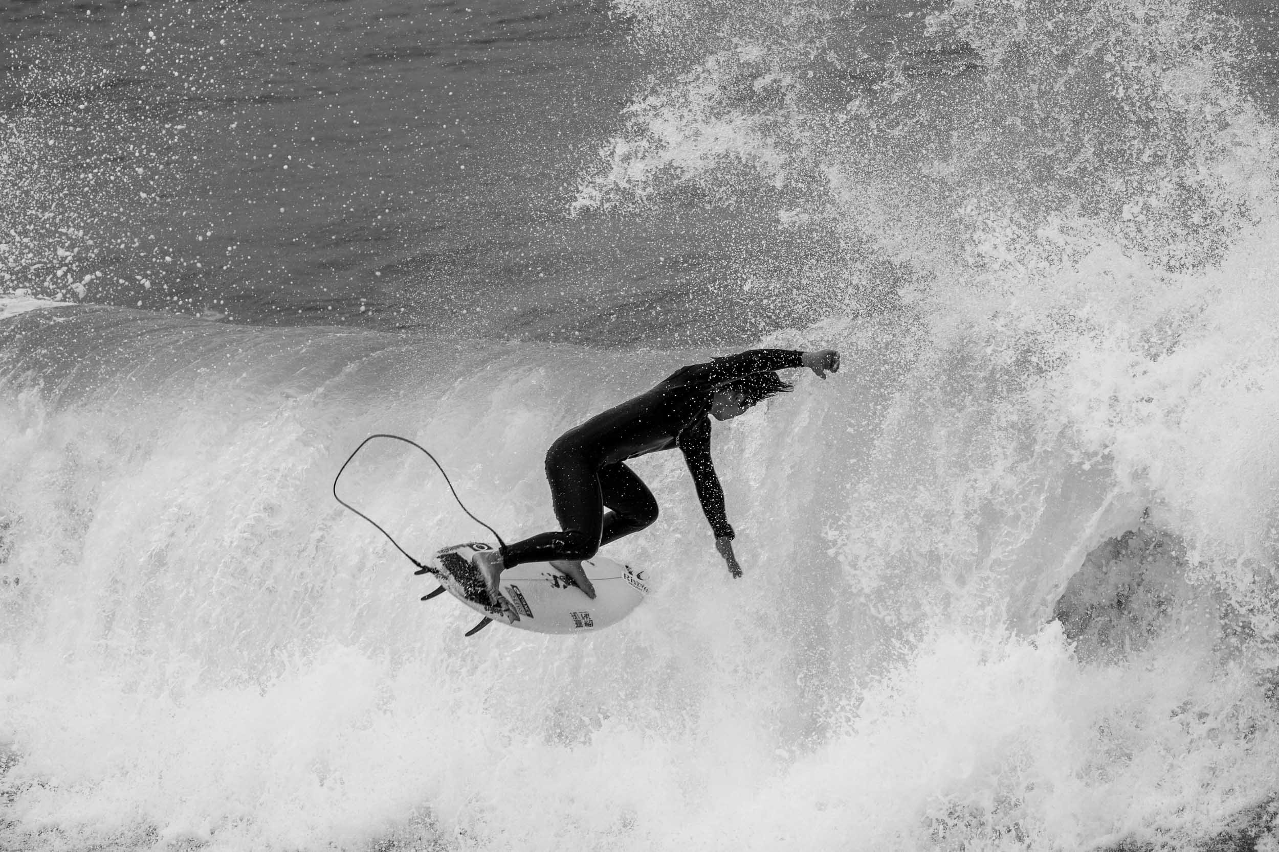 Airborne surfer silhouette in wave