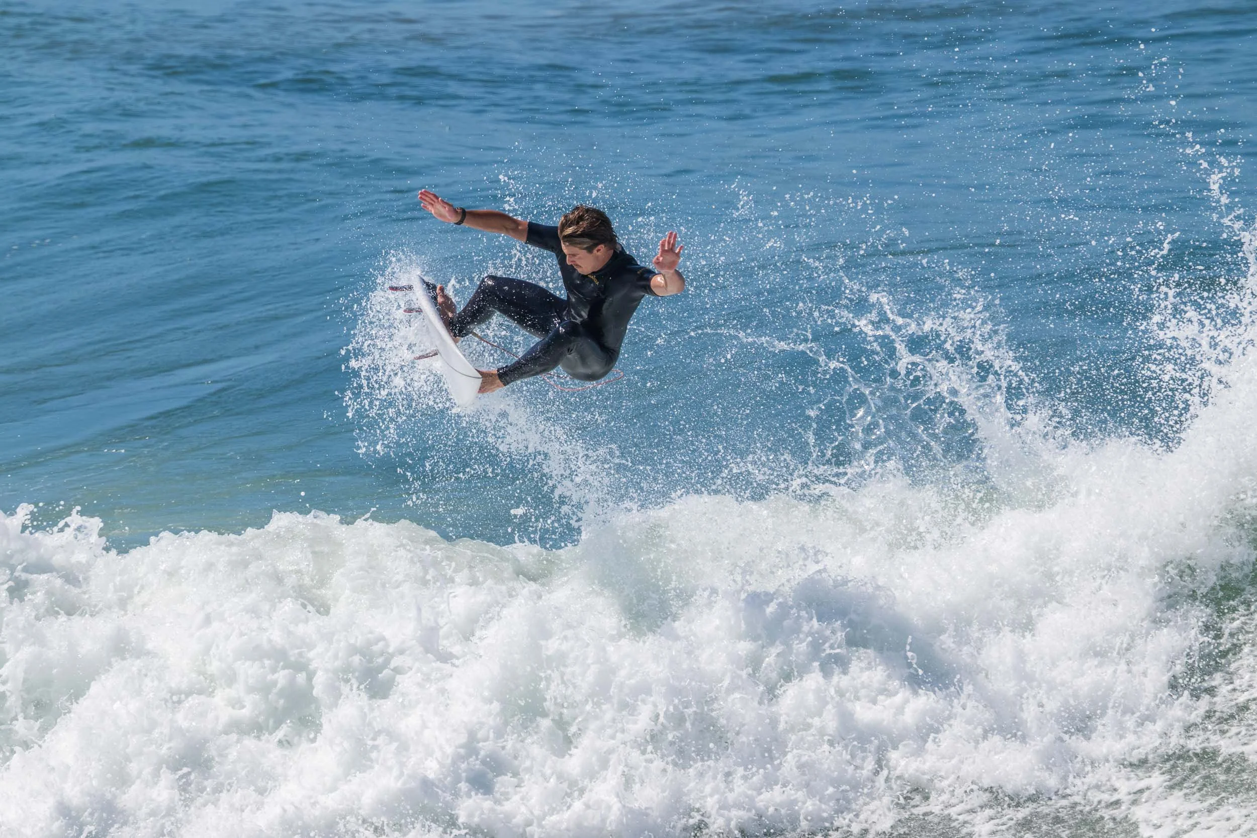 Airborne surfer at Huntington Beach
