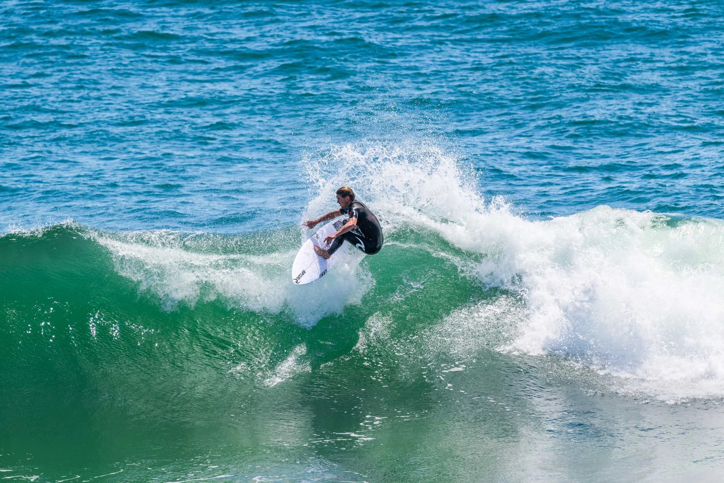 A person surfing on a wave in the ocean.