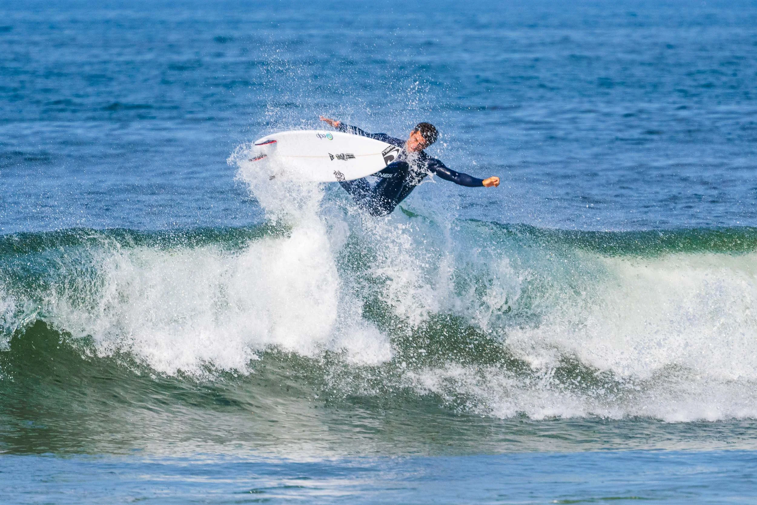 Person surfing on a wave in the ocean.