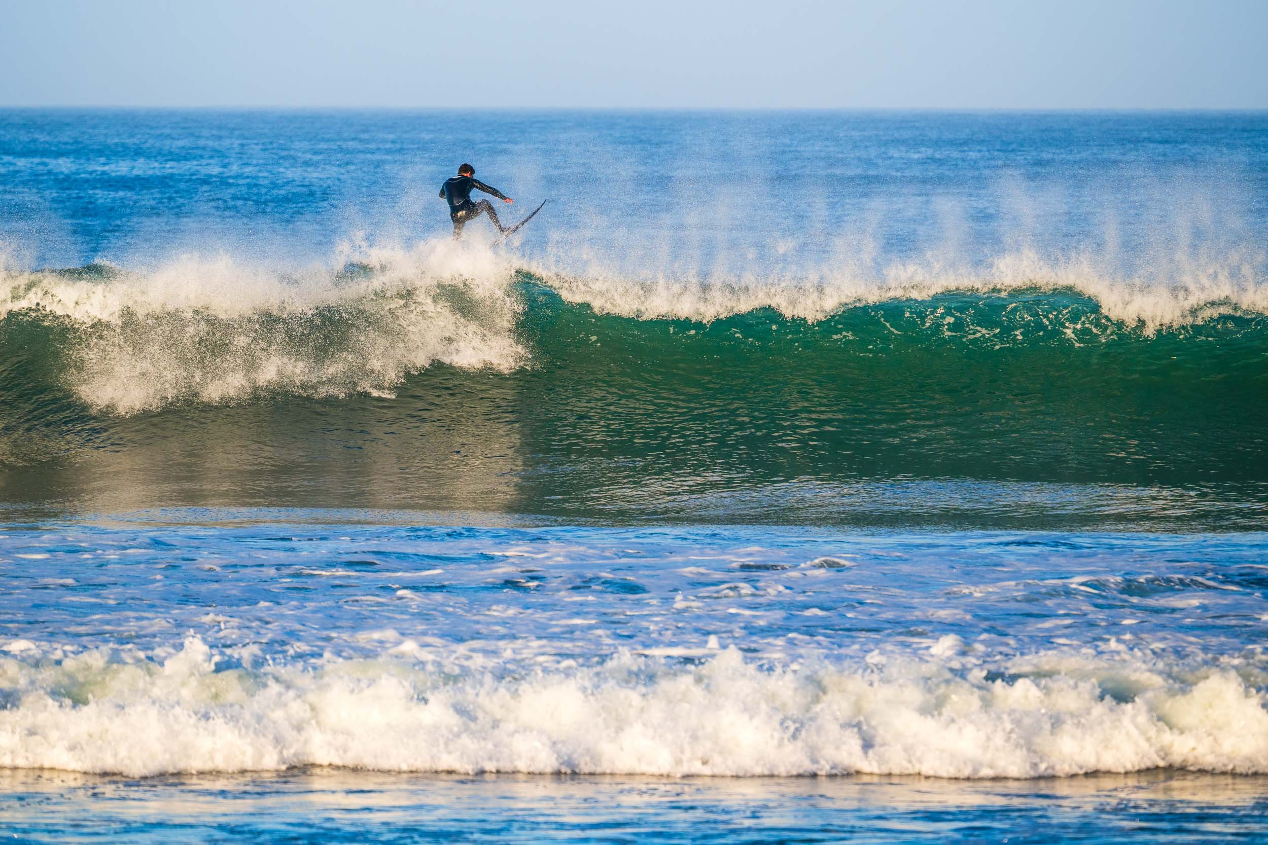 Person surfing on a wave in the ocean