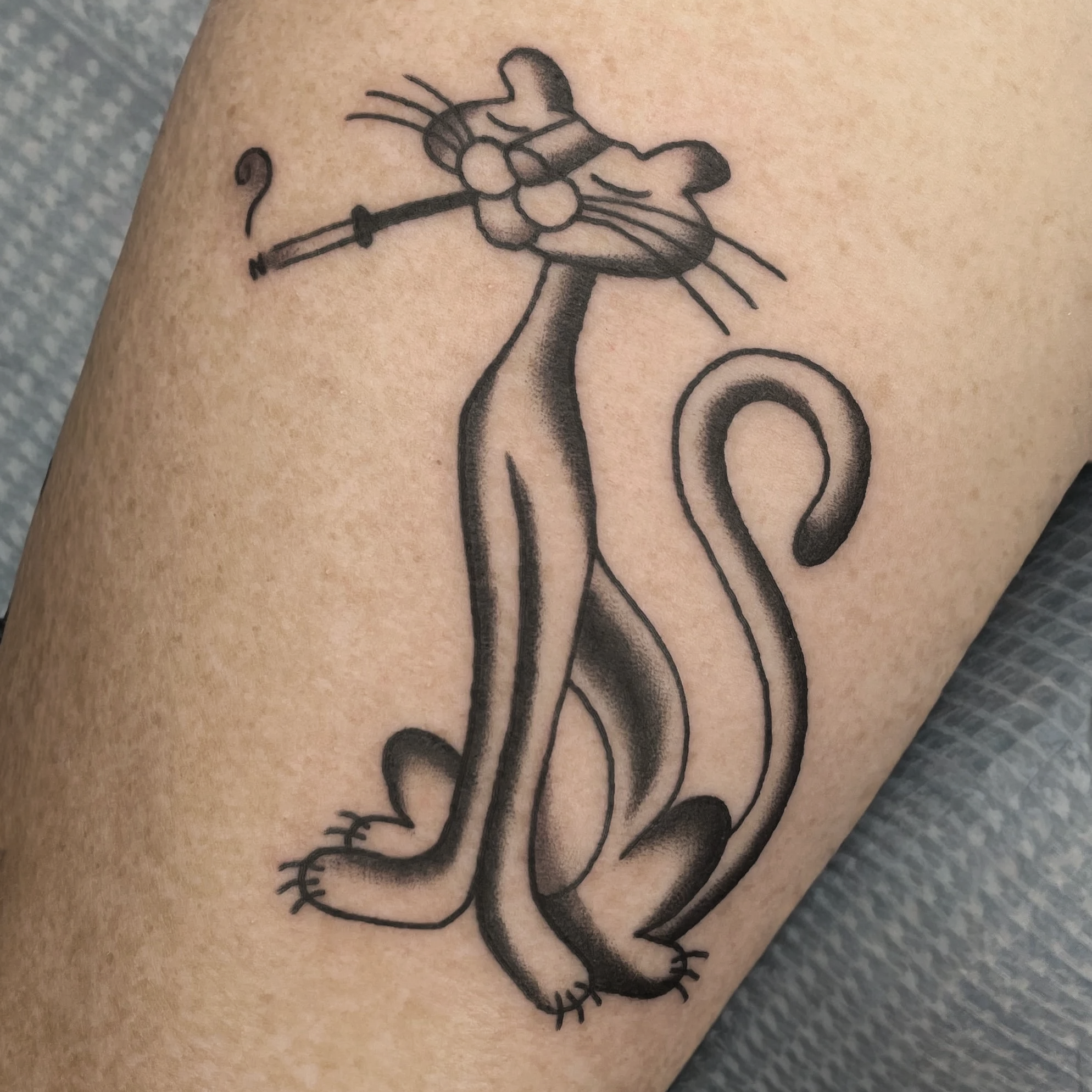 Black and grey traditional tattoo of a pink panther.