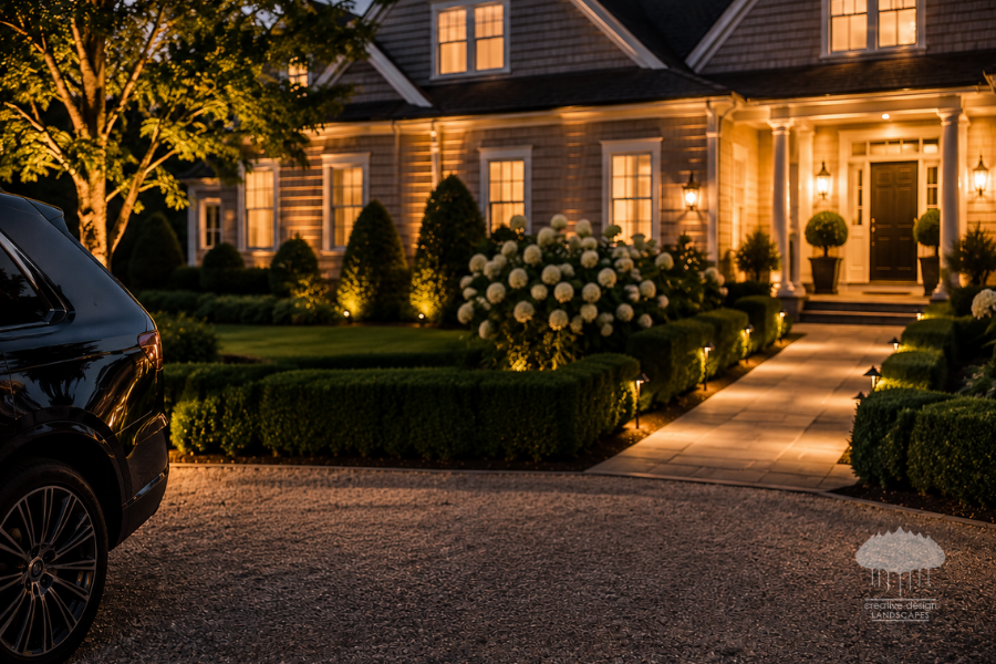 Landscape crew completing a guest-ready Hamptons landscaping walk-through at dusk”