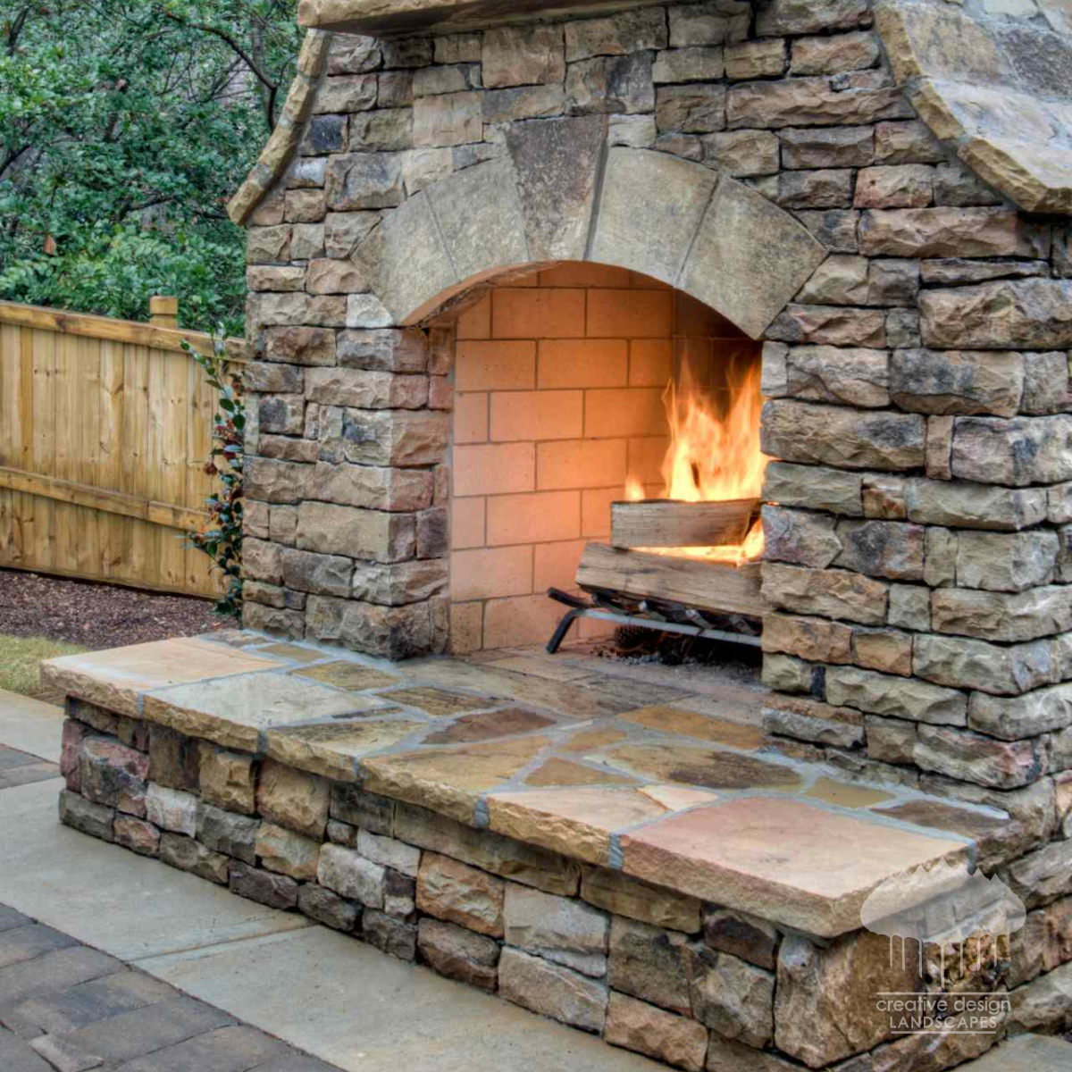 natural-stone-outdoor-fireplace-arched-hearth.png