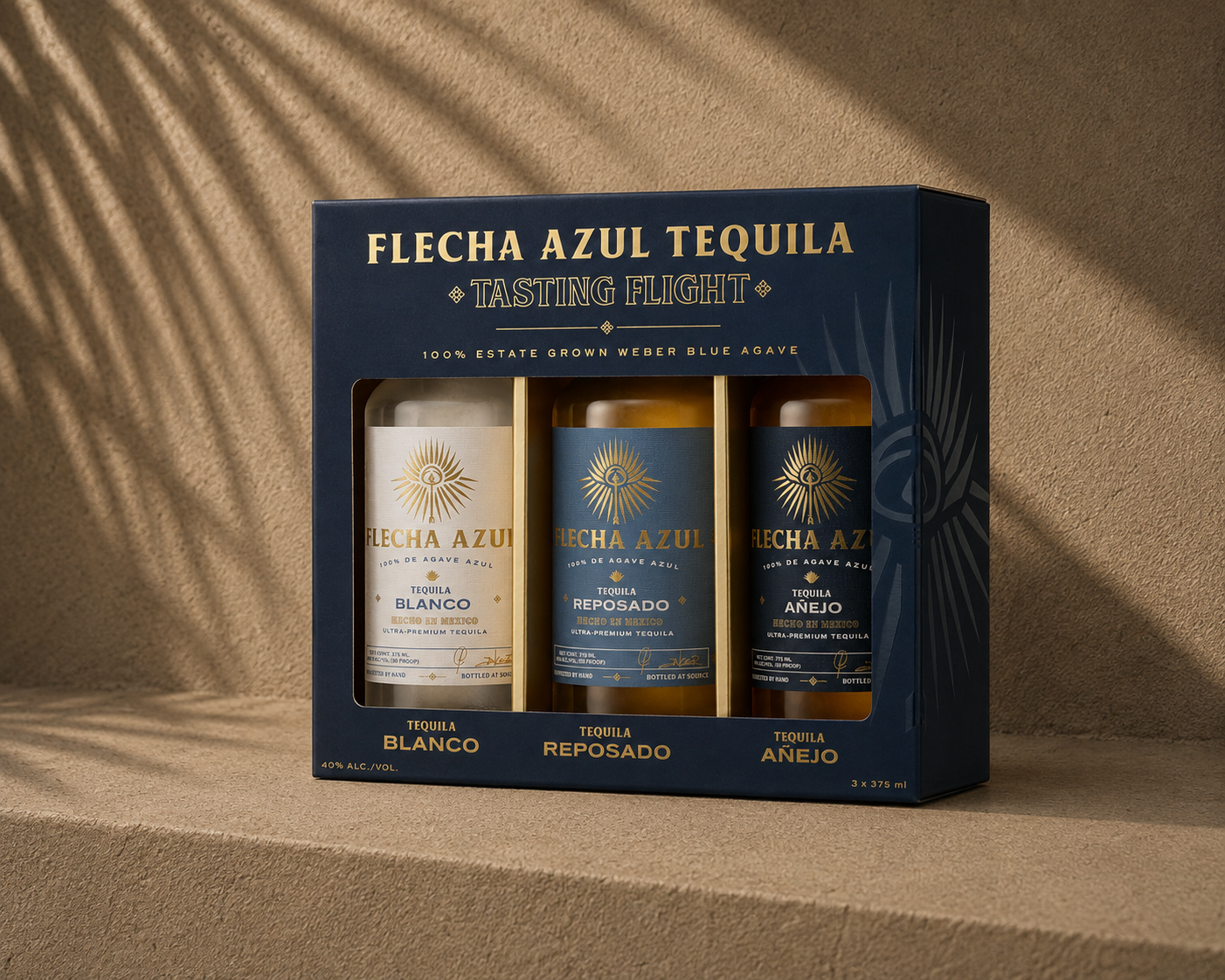 Box of Flecha Azul Tequila tasting flight with three small bottles labeled Blanco, Reposado, and Añejo, on a beige surface with shadows.