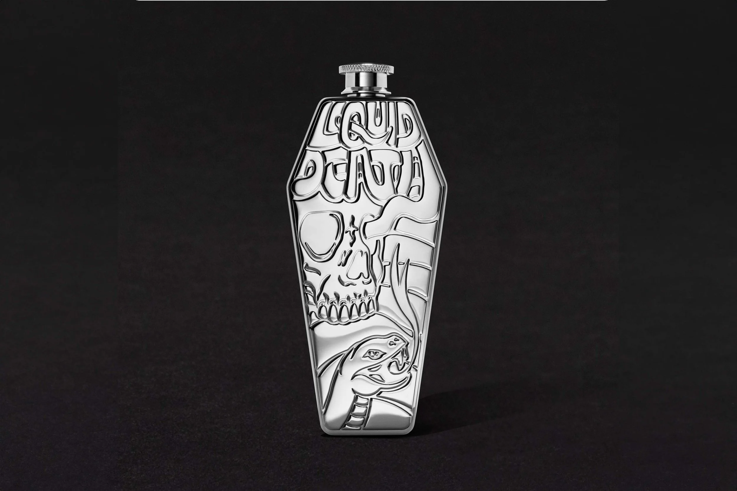 A metallic bottle with engraved skull and skeletal imagery on a black background.