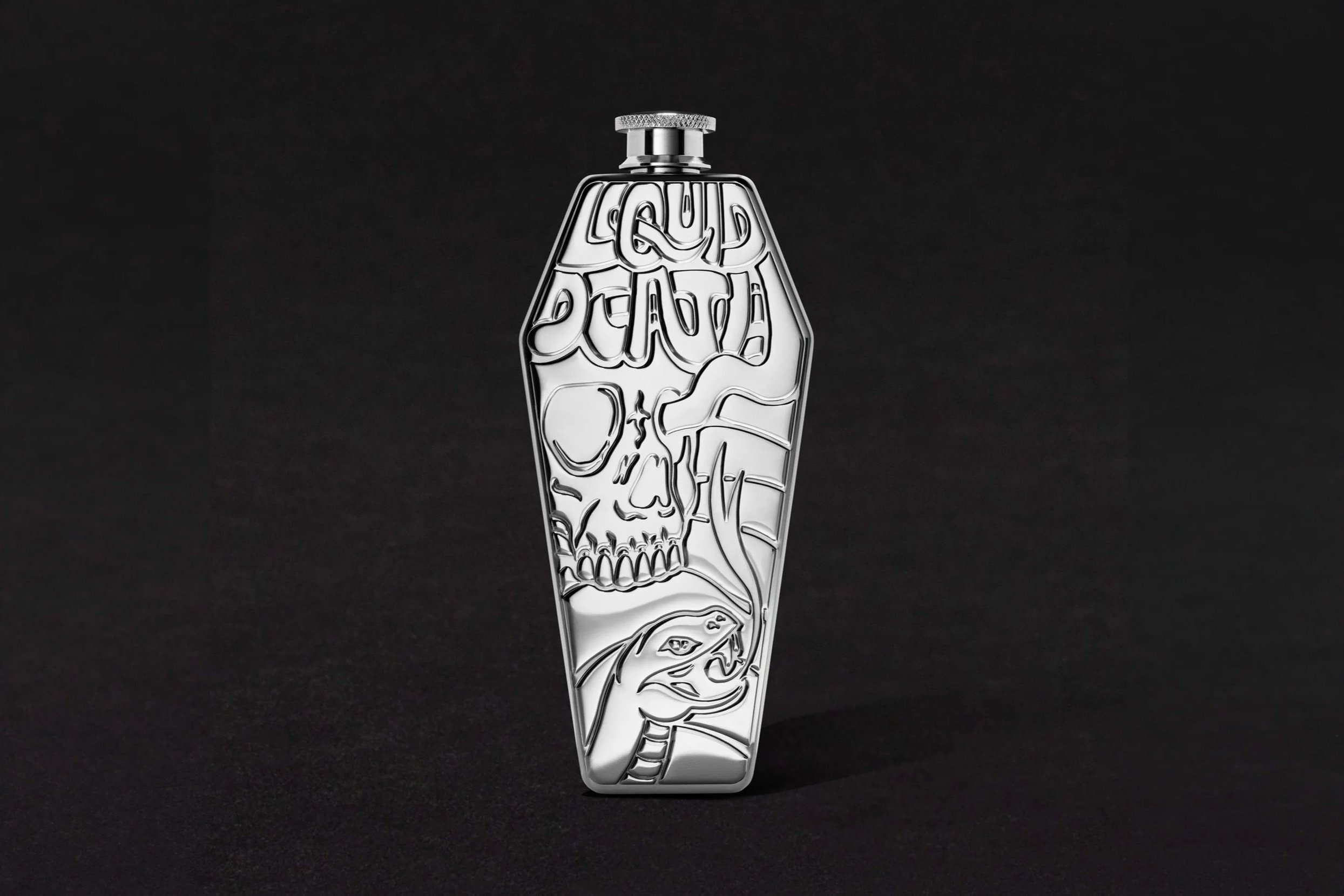 A metallic bottle opener with a design of a skull and brain outline engraved on it, set against a black background.